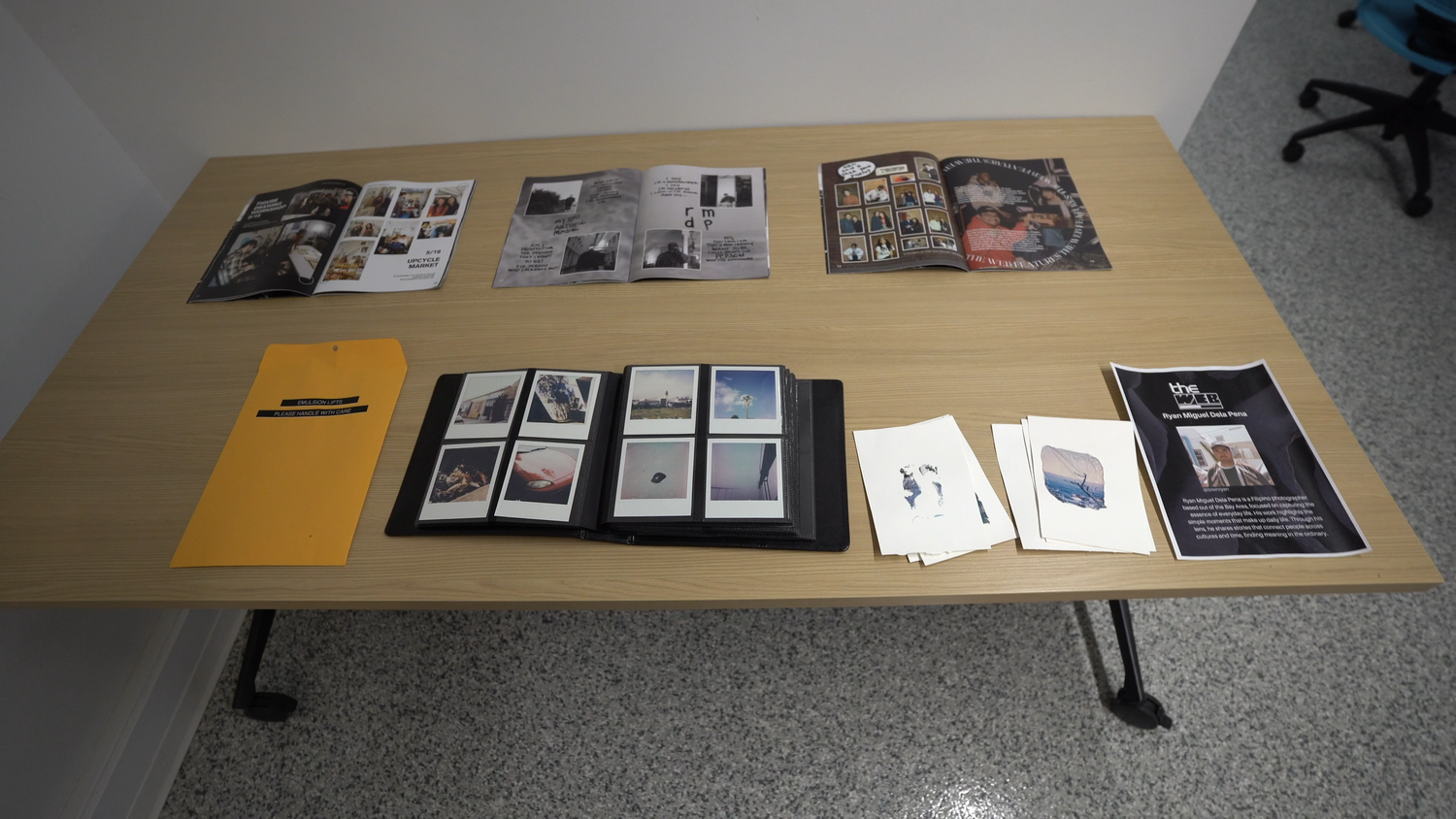Printed programs and exhibition materials laid out on a table.