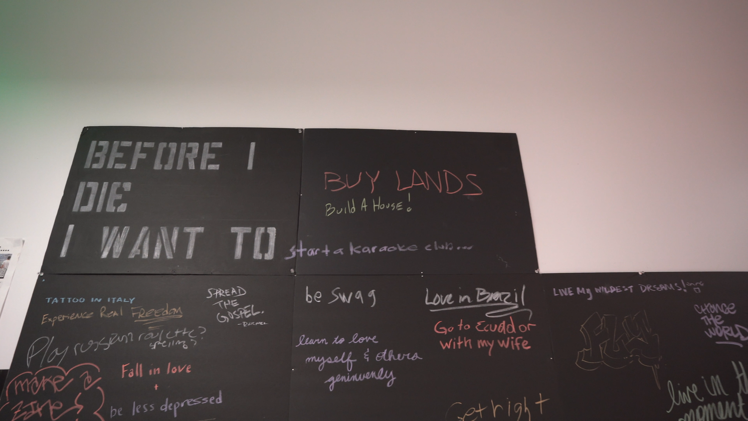 The Before I Die wall filled with handwritten contributions.