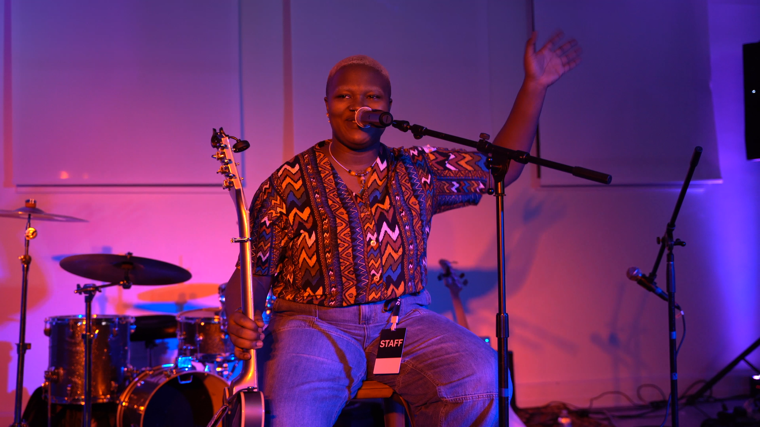 A vocalist raises a hand during the performance.