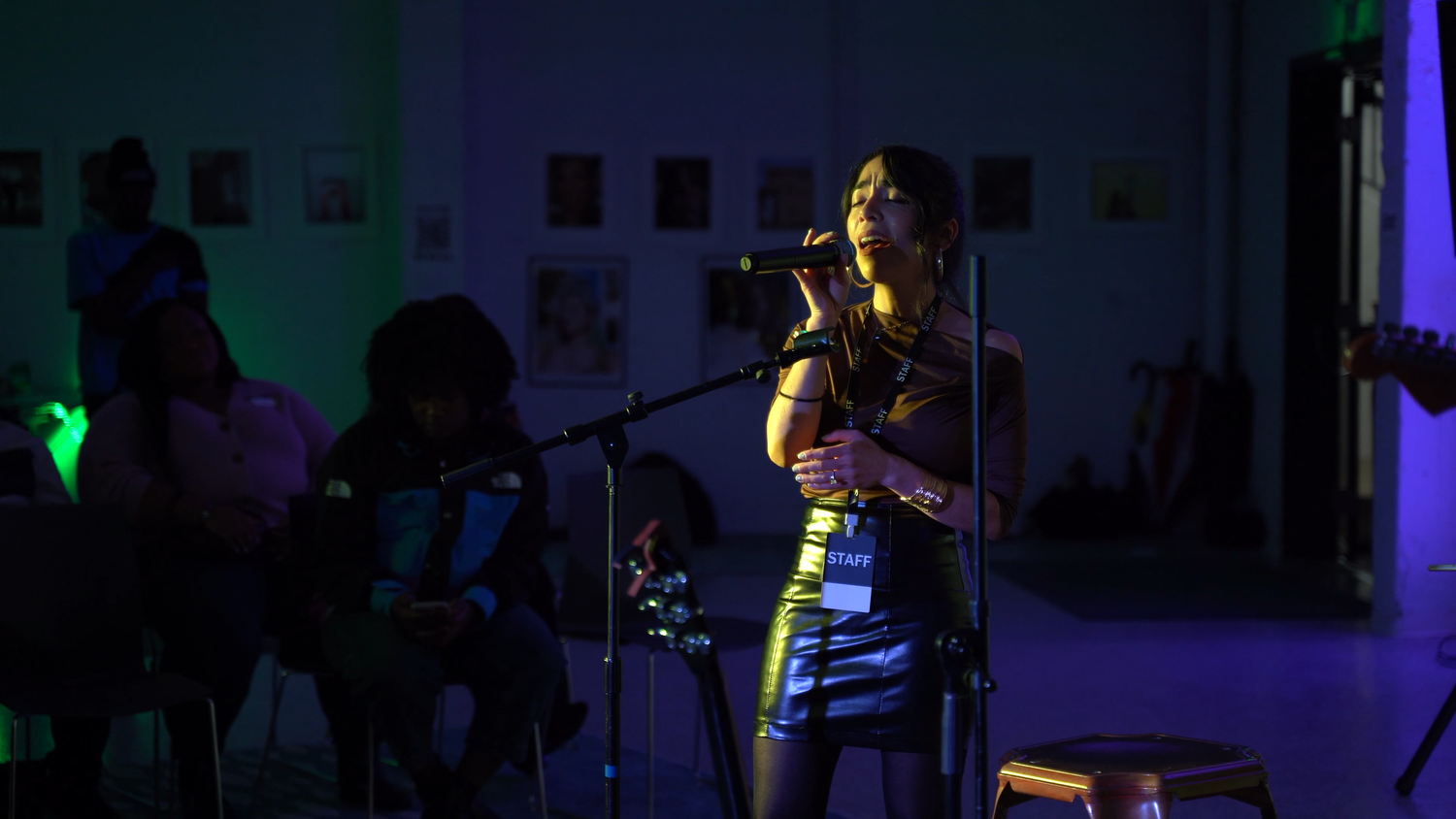 A vocalist smiles while holding the microphone.