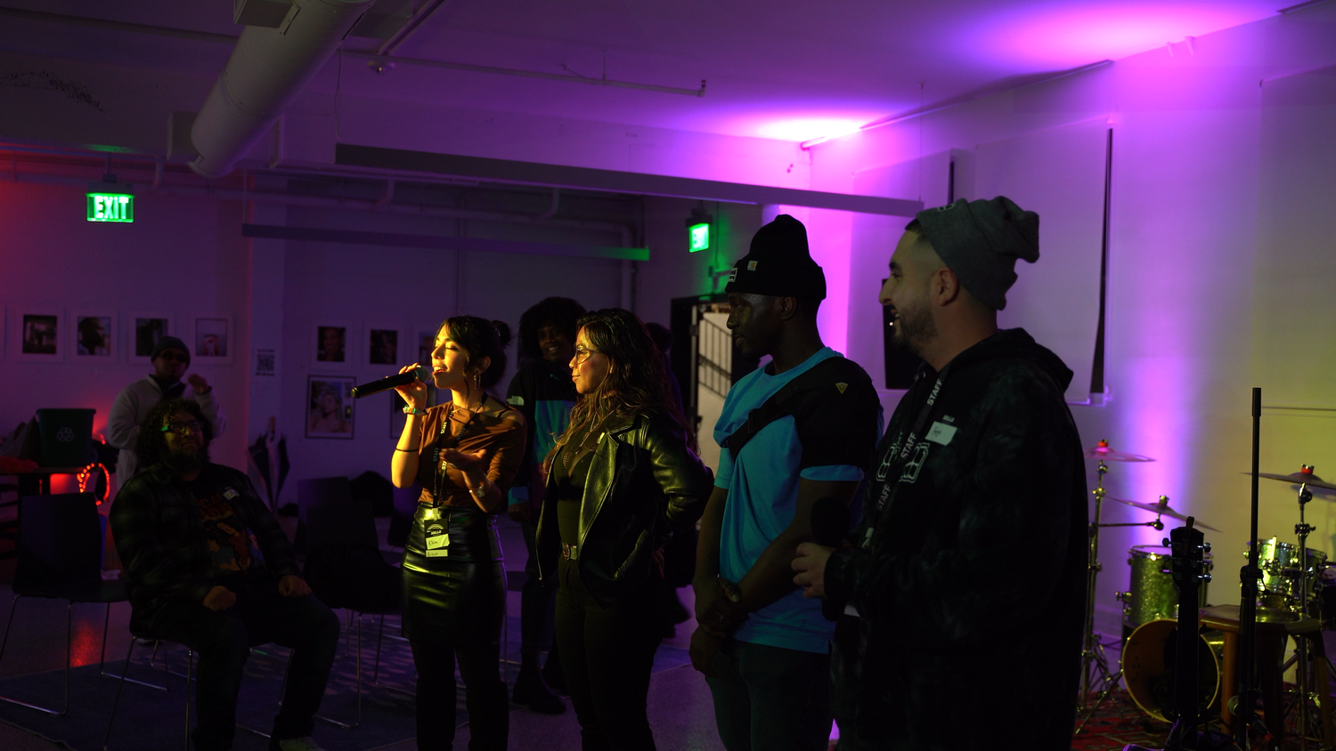 Performers and guests gather at the edge of the stage.