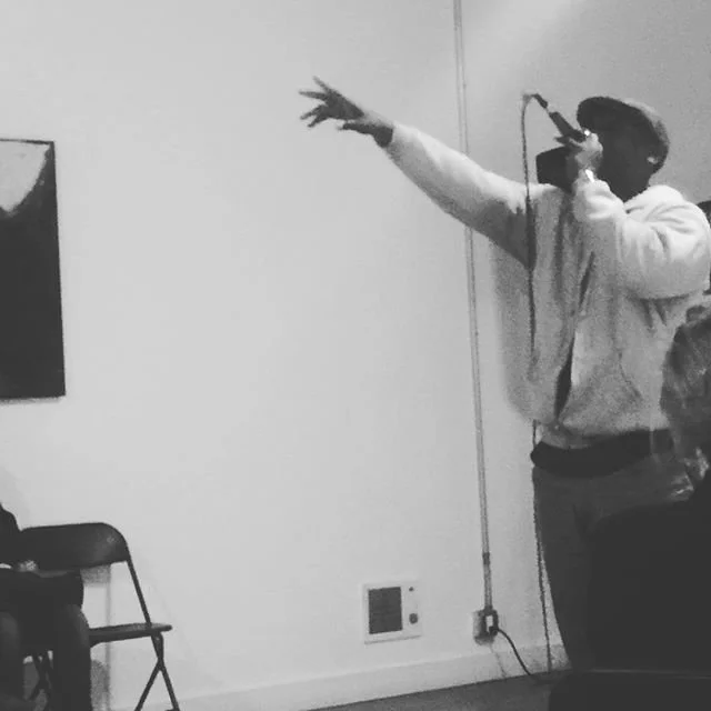 A performer gestures with an outstretched arm.