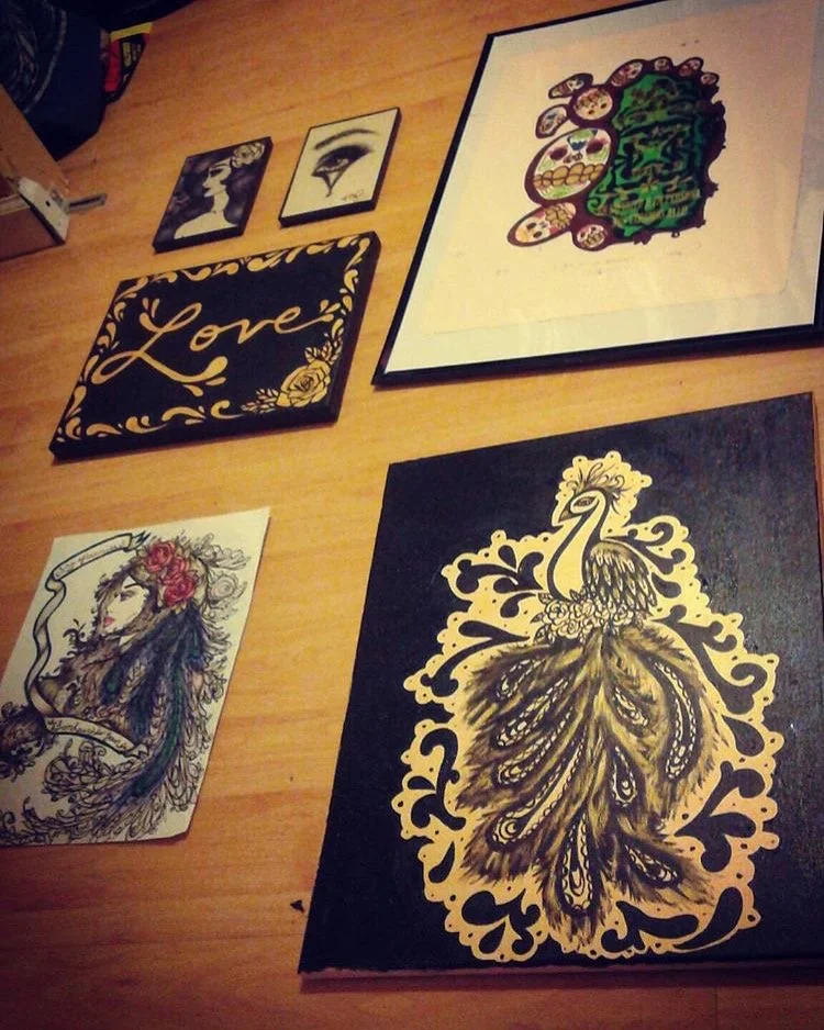 Decorative artwork arranged on a wooden floor.