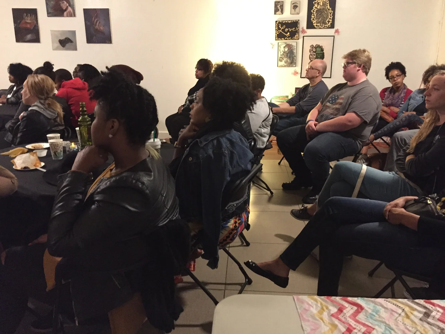 Guests sit together along the gallery wall.