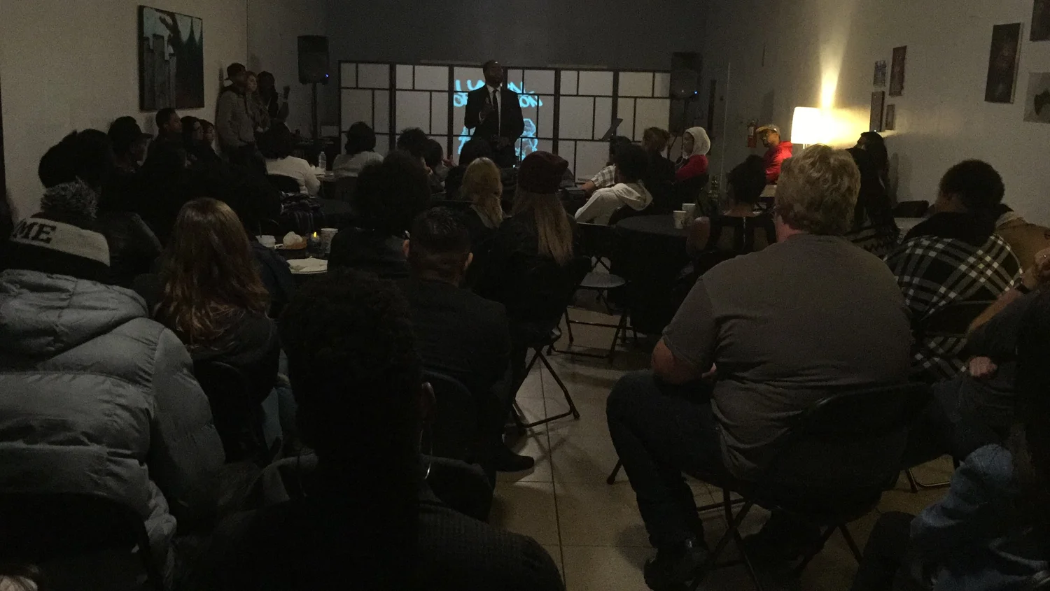 Audience members listen during the open mic.
