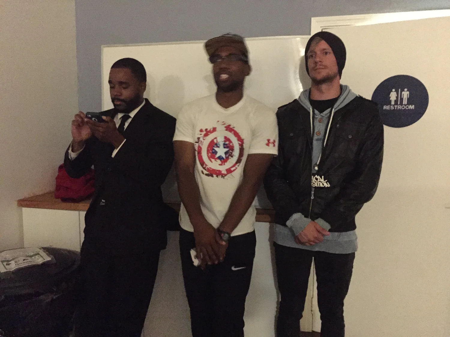 Three participants pose together after the open mic.