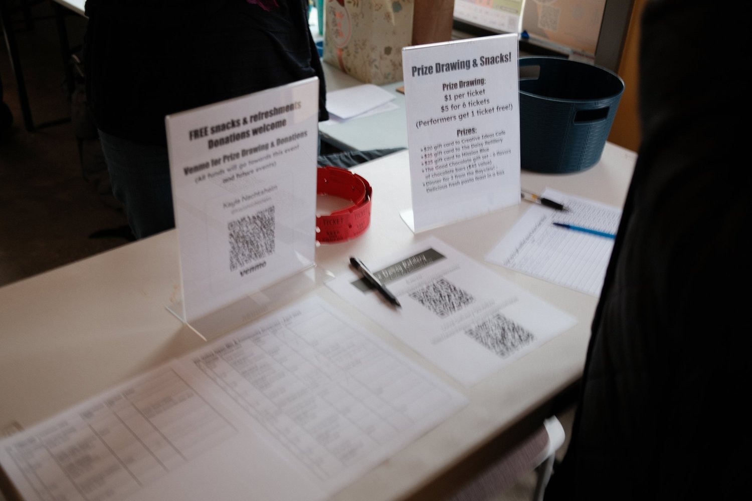 Event information and QR codes displayed at a welcome table.
