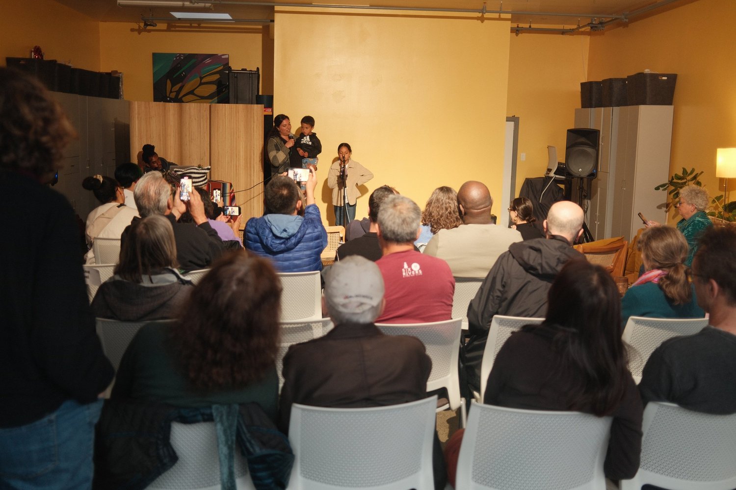 Audience facing participants at the microphone.