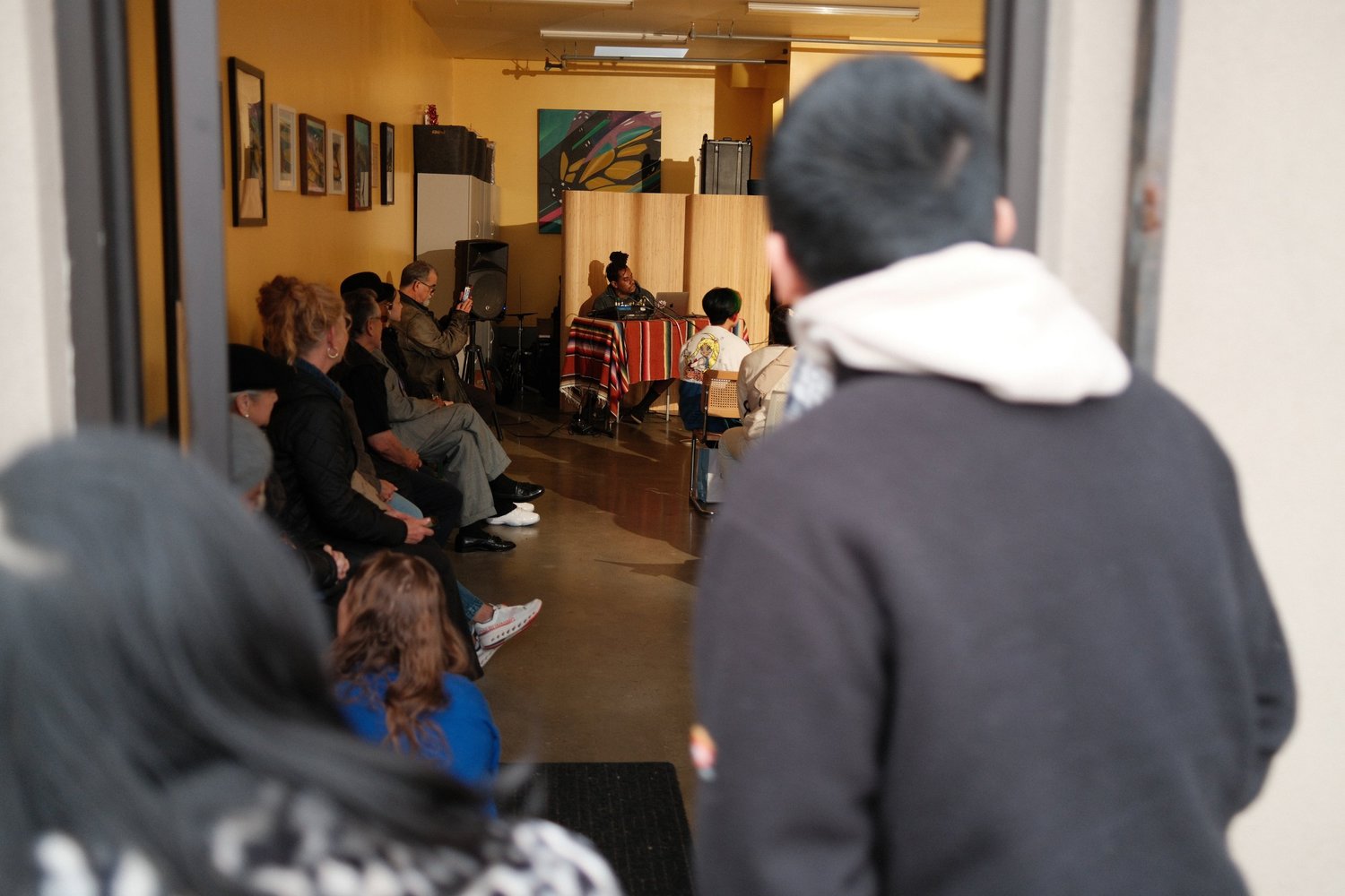 View through the doorway into the open-mic gathering.