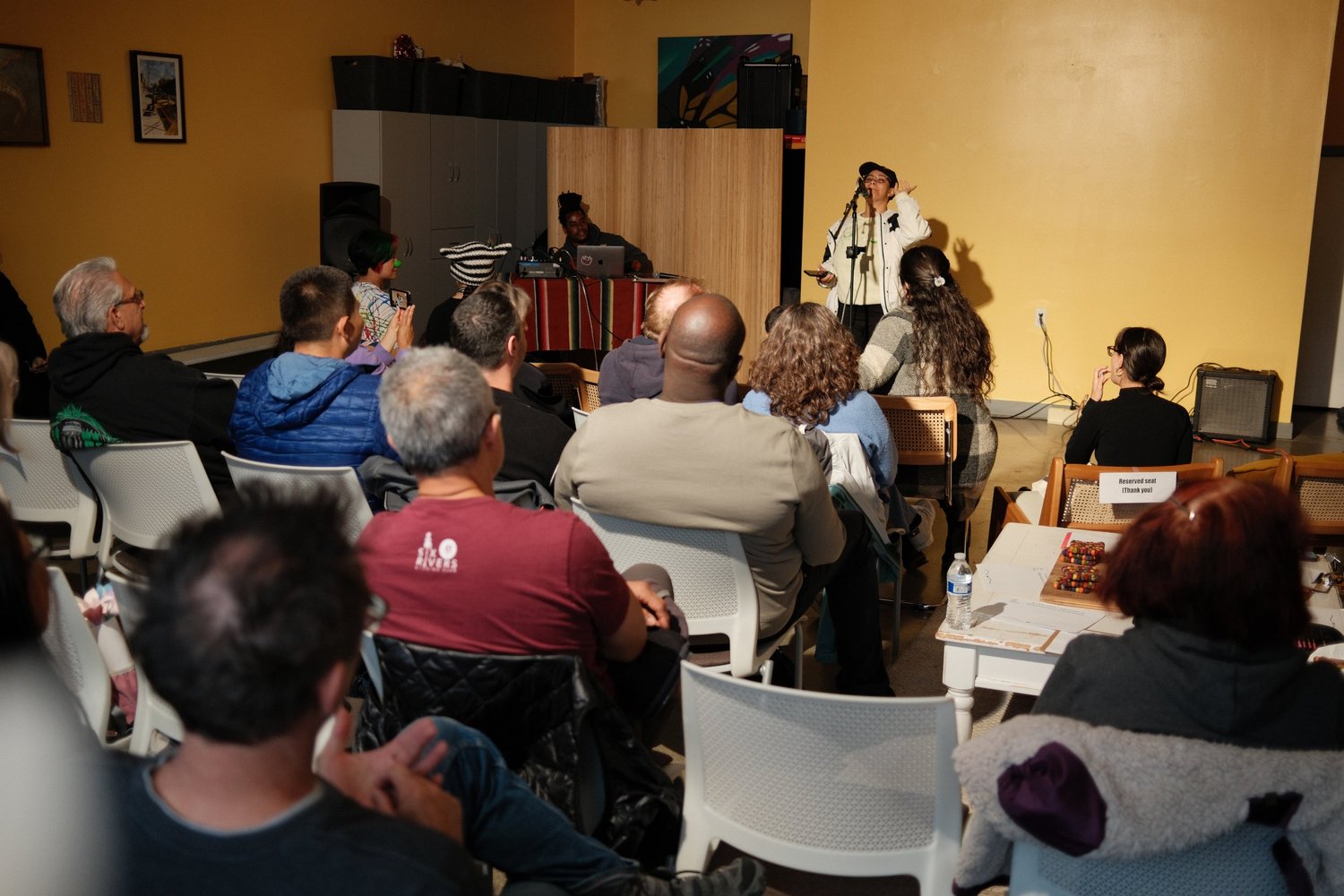 View past seated listeners toward the performer.