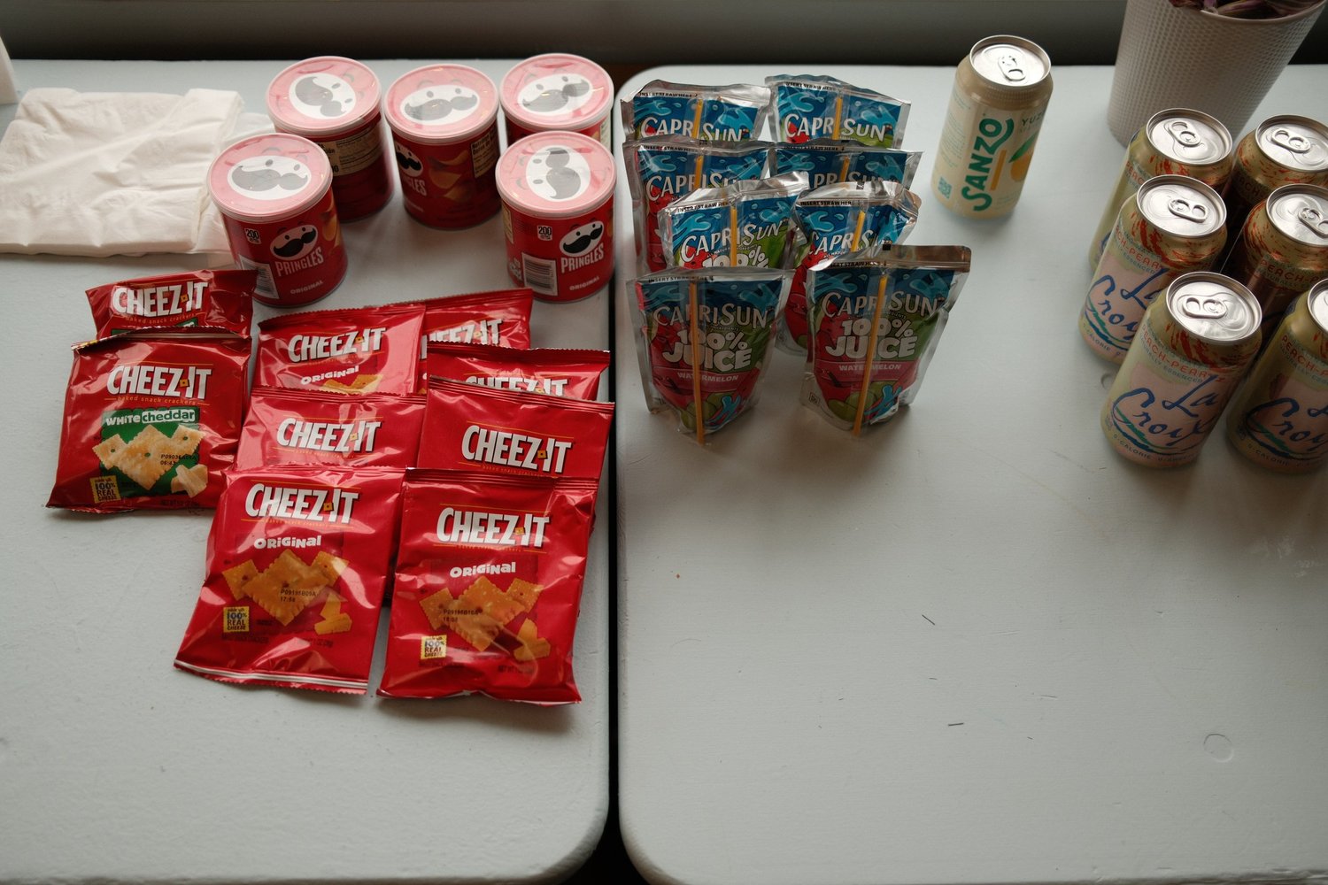 Packaged snacks and canned drinks arranged for attendees.