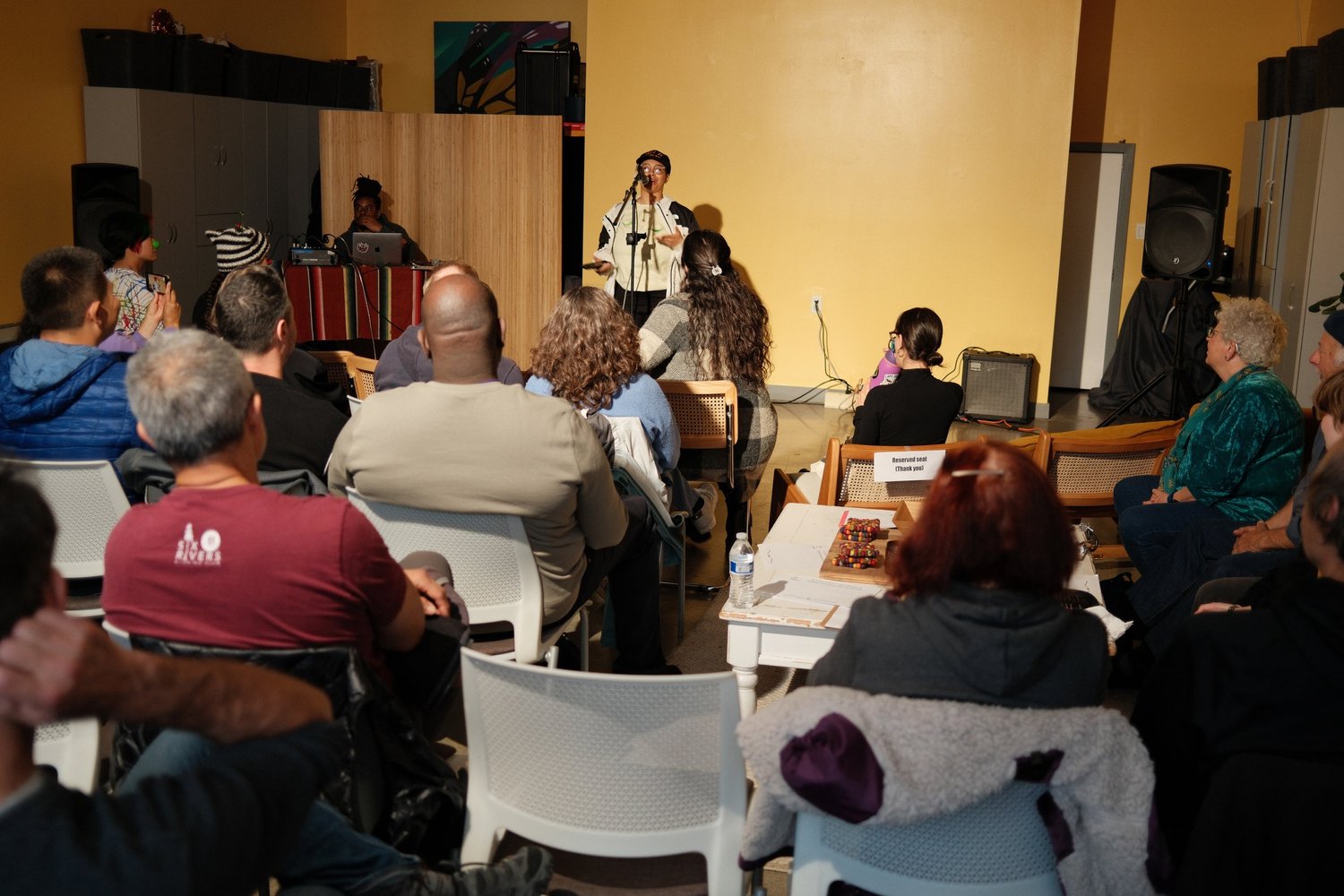 Audience watching the open-mic performer.