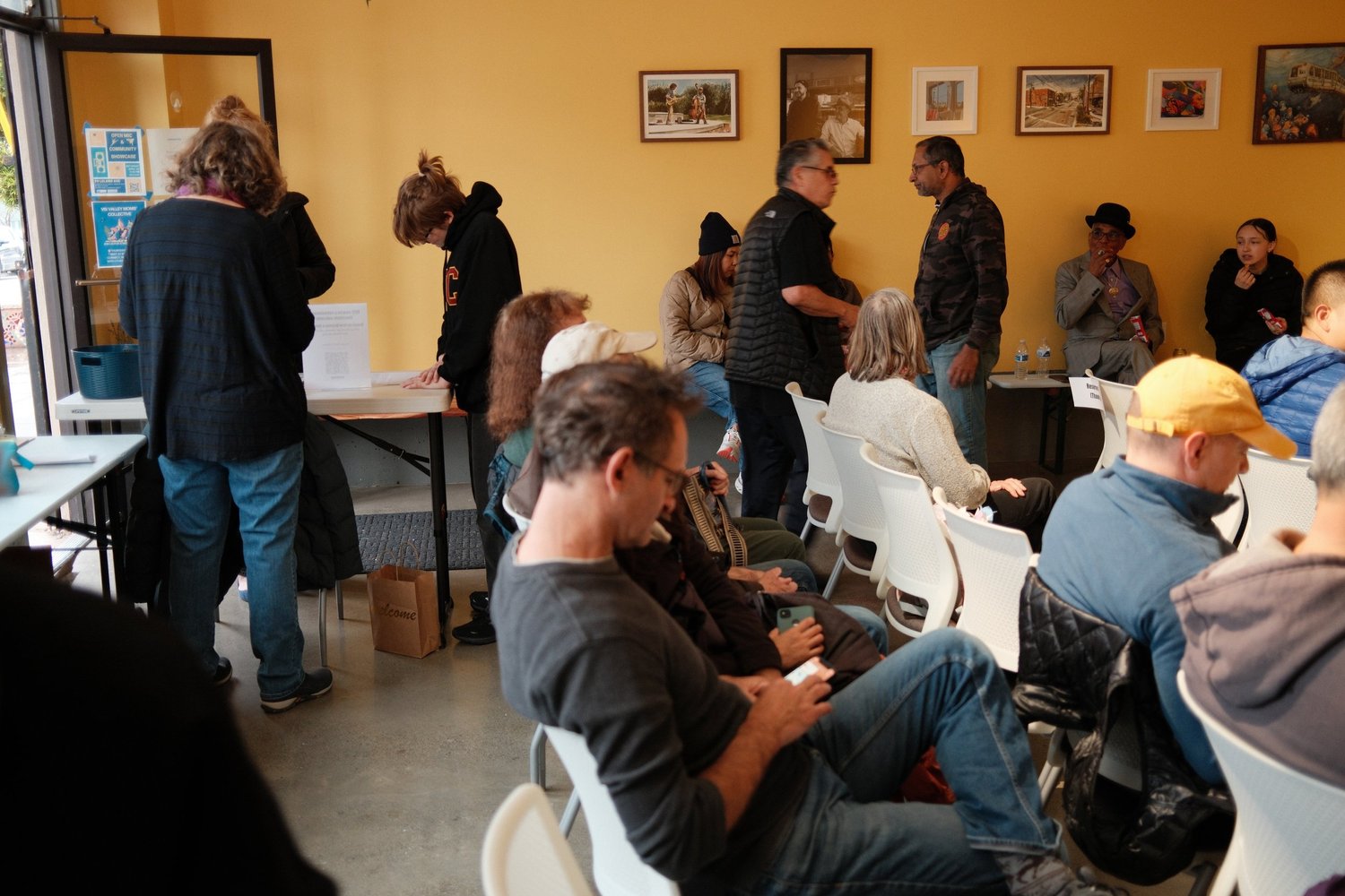 Attendees talking near the window between performances.