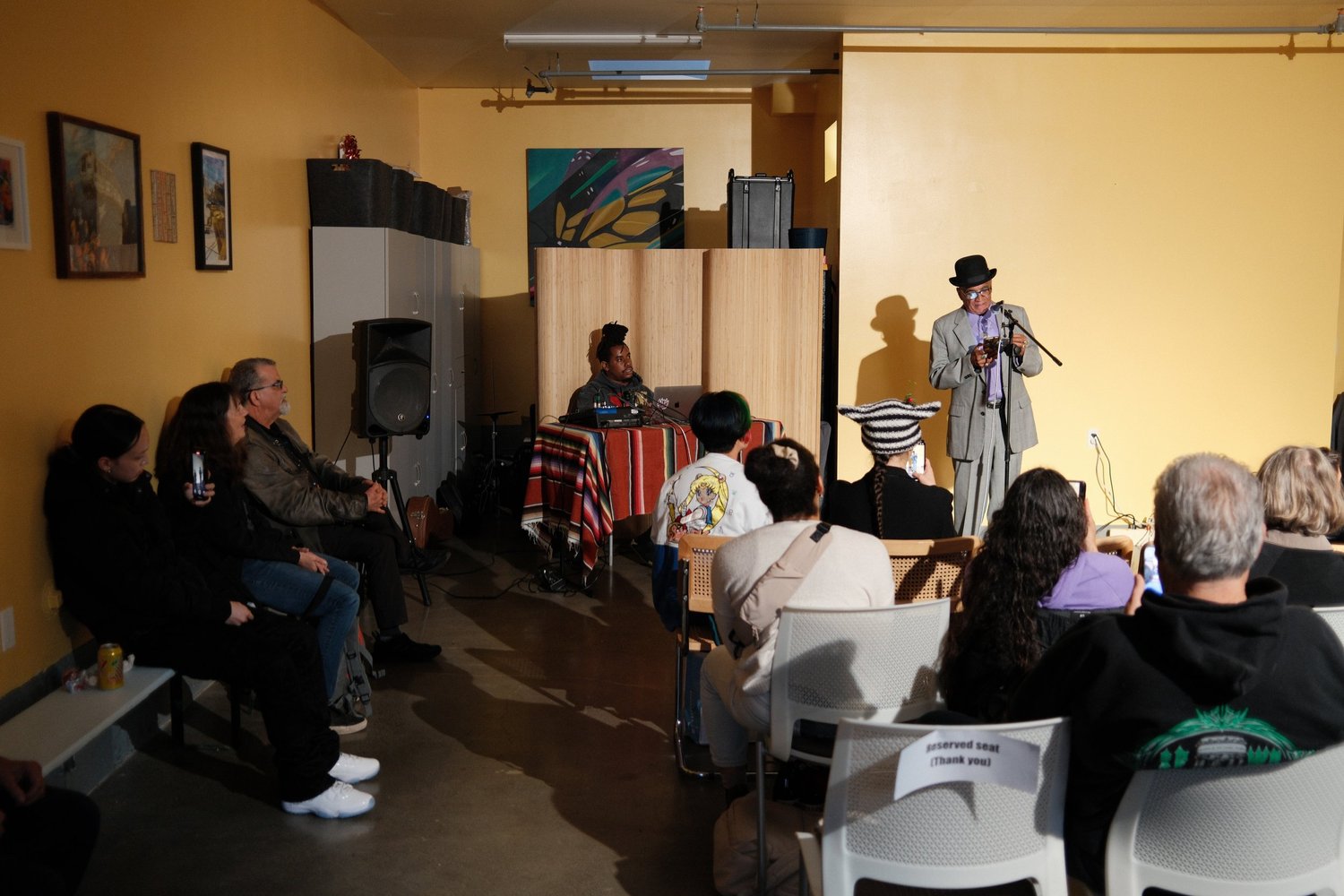 Wide view of the performer beside the sound table.