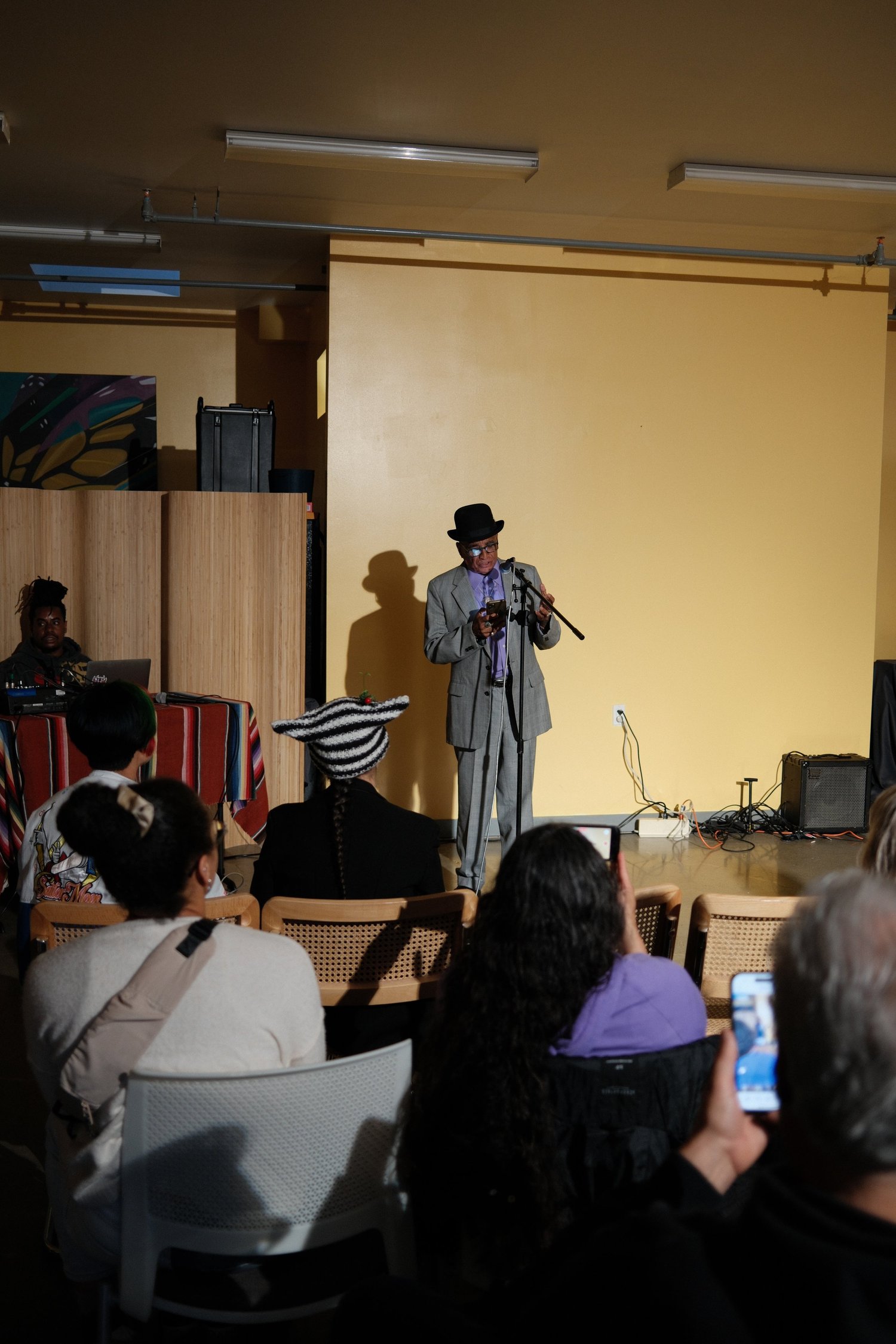 Vertical view of the performer reading into a microphone.