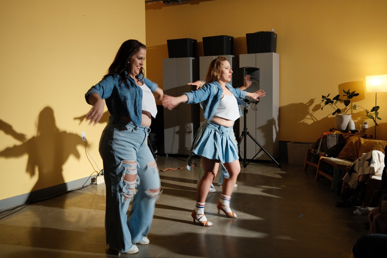 Two dancers in denim performing together.