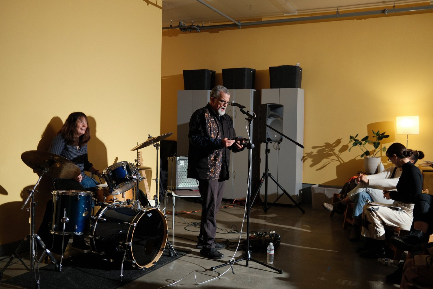 Guitarist and drummer performing together.