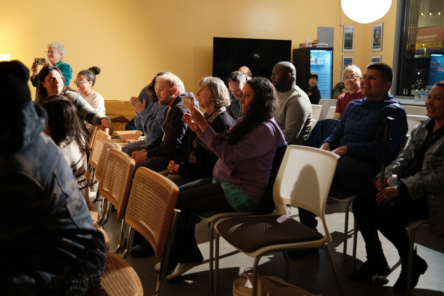 Audience applauding from rows of chairs.