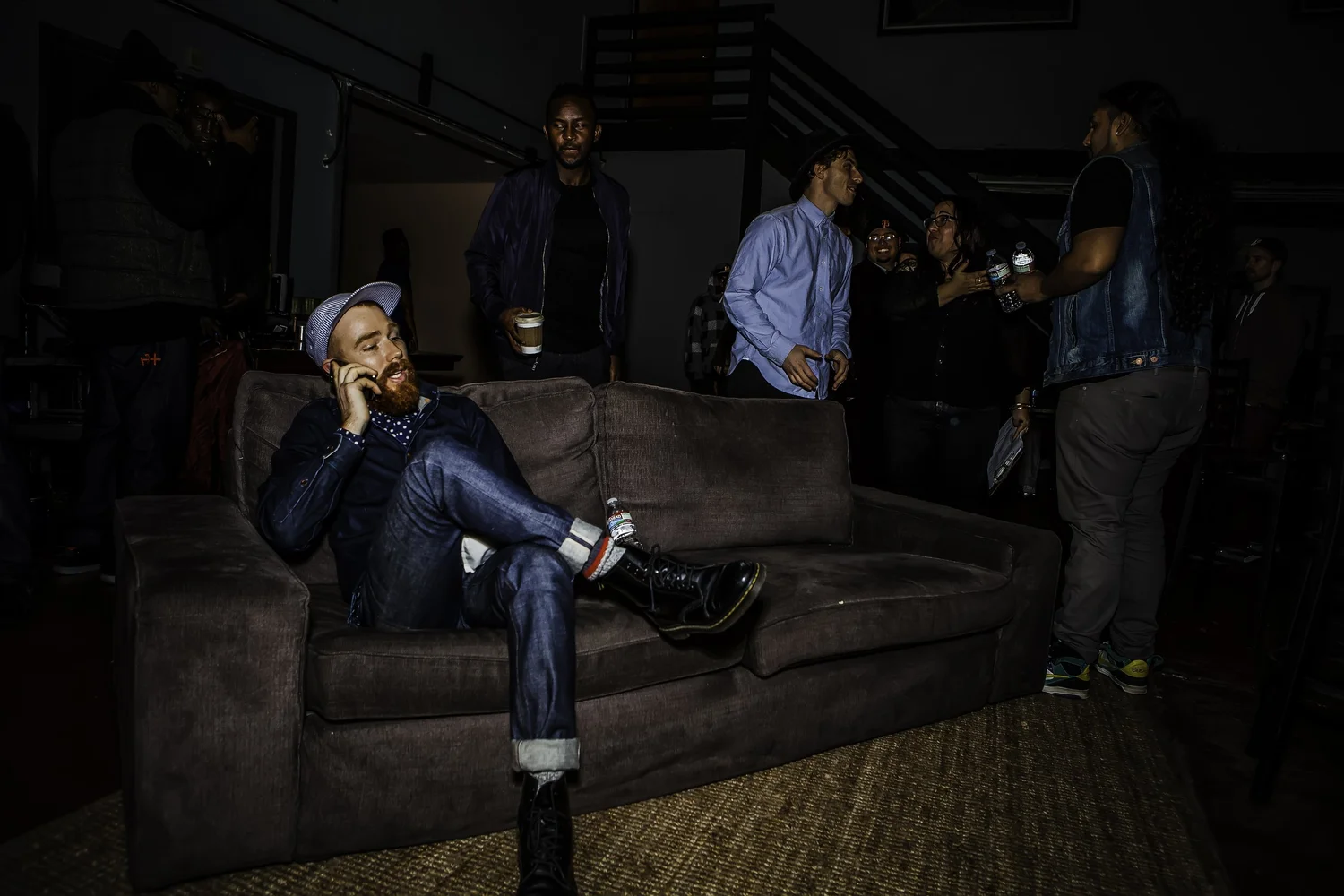 Attendee reclining on a sofa inside the venue.
