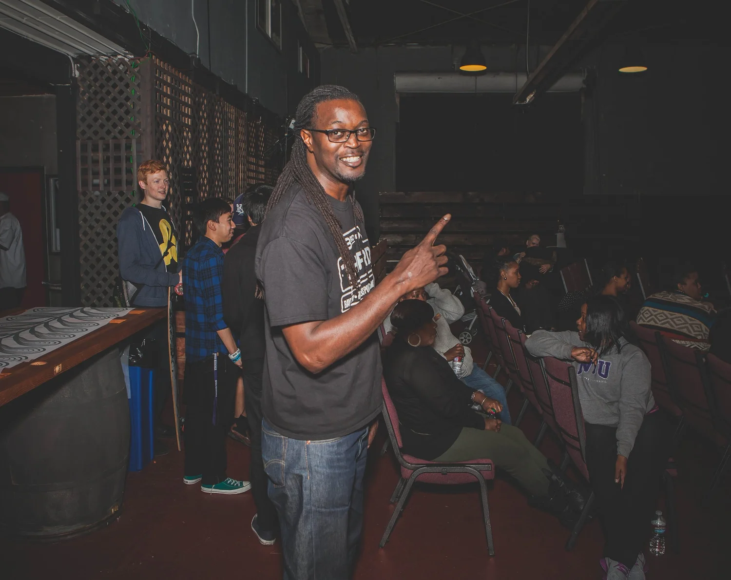 Smiling attendee flashing a peace sign.
