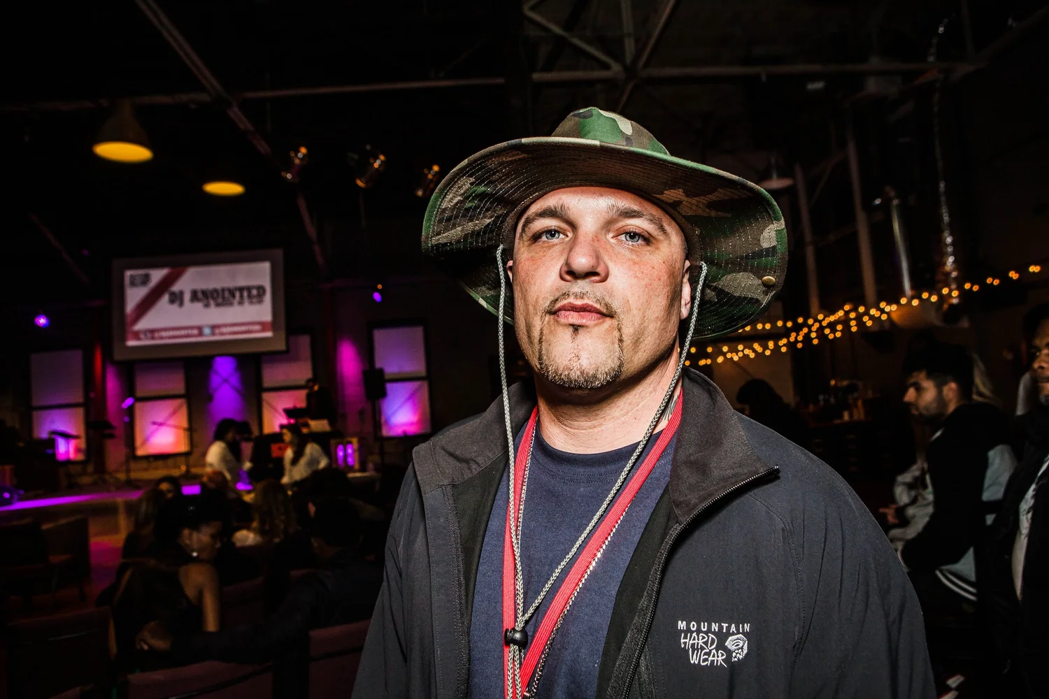 Portrait of an attendee wearing a camouflage hat.