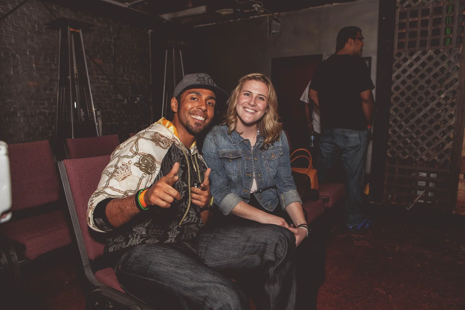 Two attendees smiling while seated.