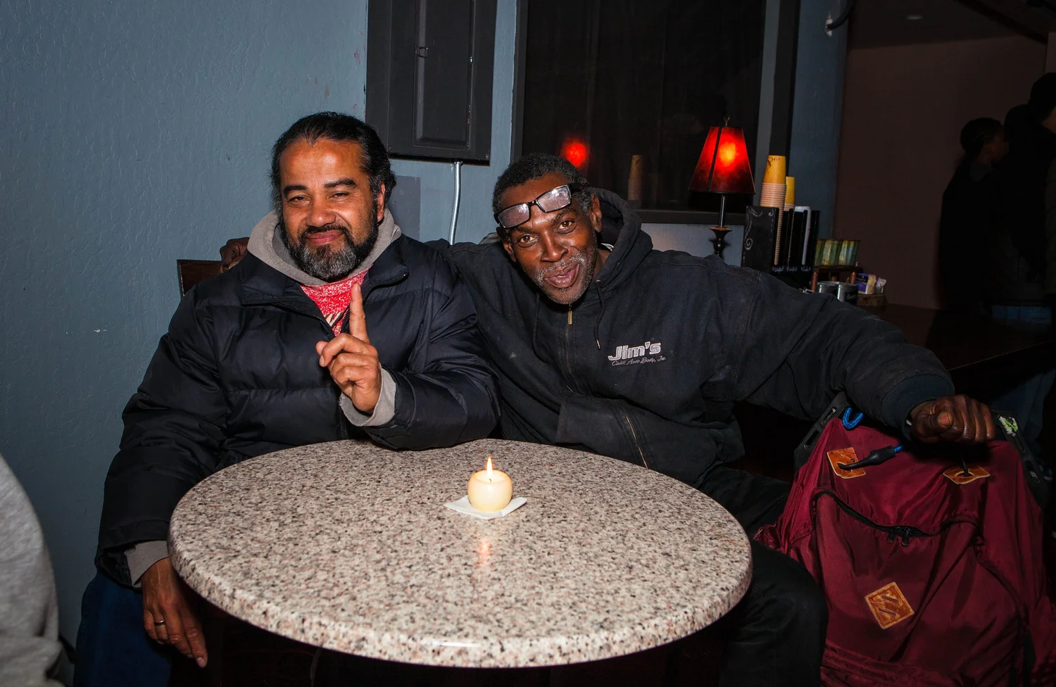 Two attendees smiling at a small round table.