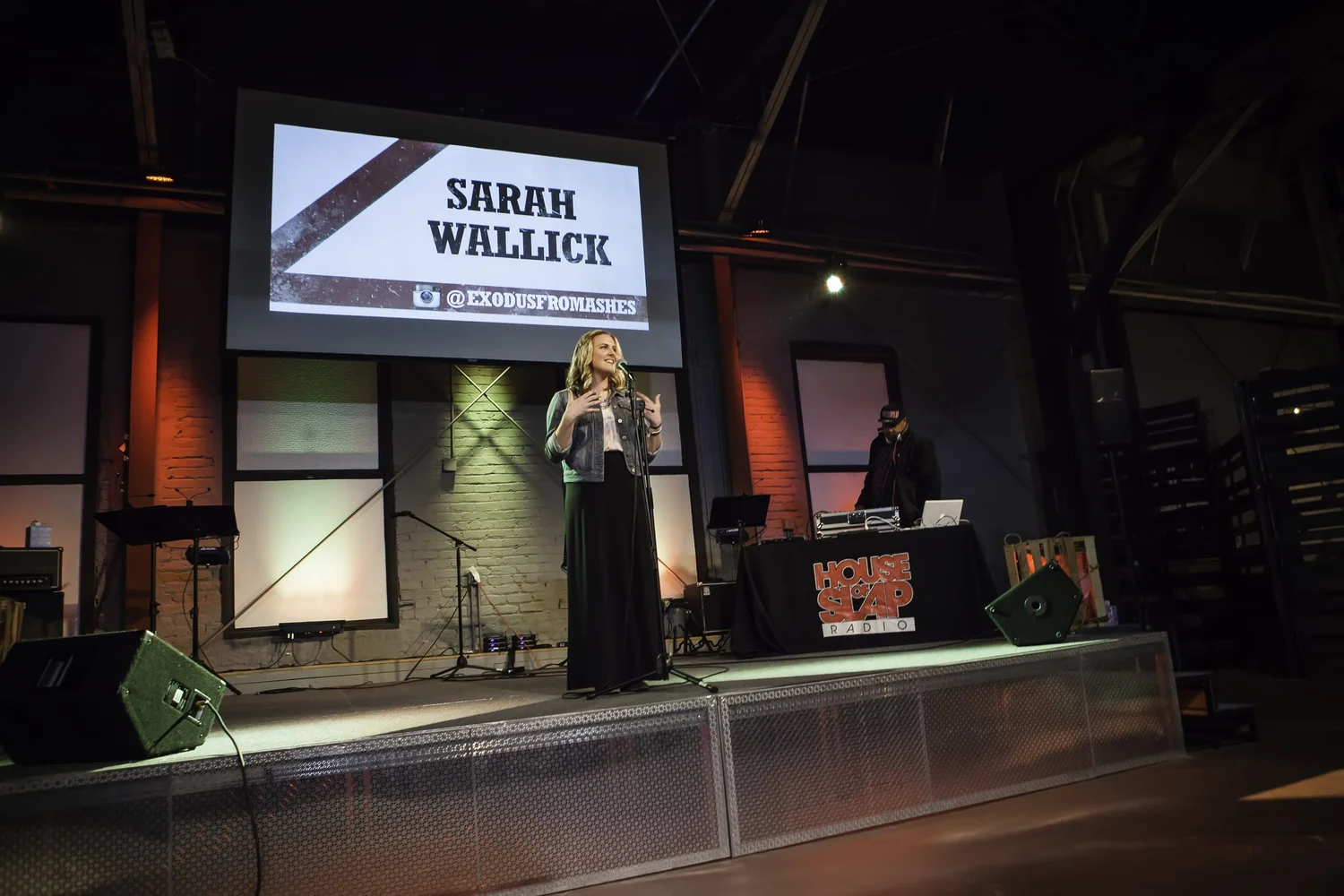 Vocalist beneath a Sarah Wallick projection.