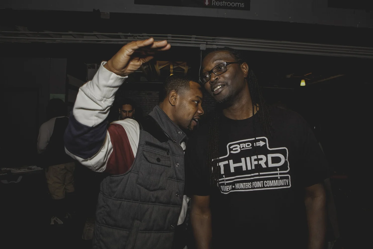 Two participants posing together, one raising an arm.