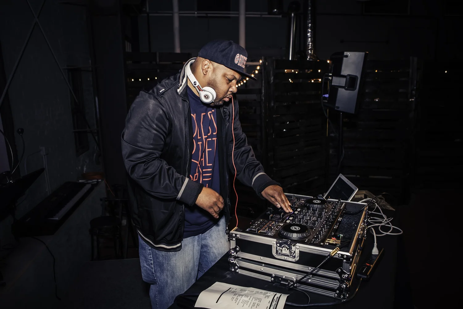DJ working at a mixer and laptop.