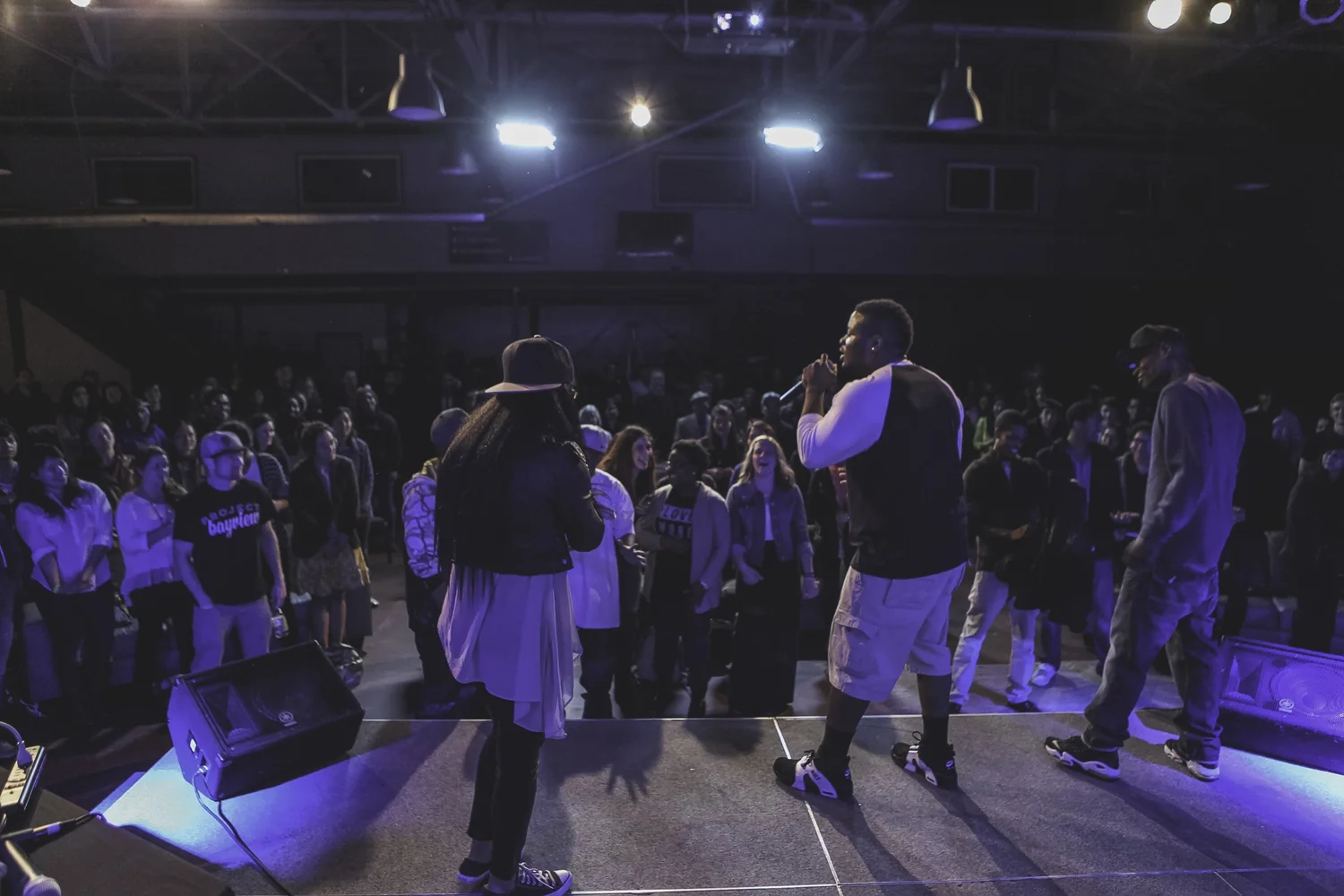 Several performers facing the audience from the stage.