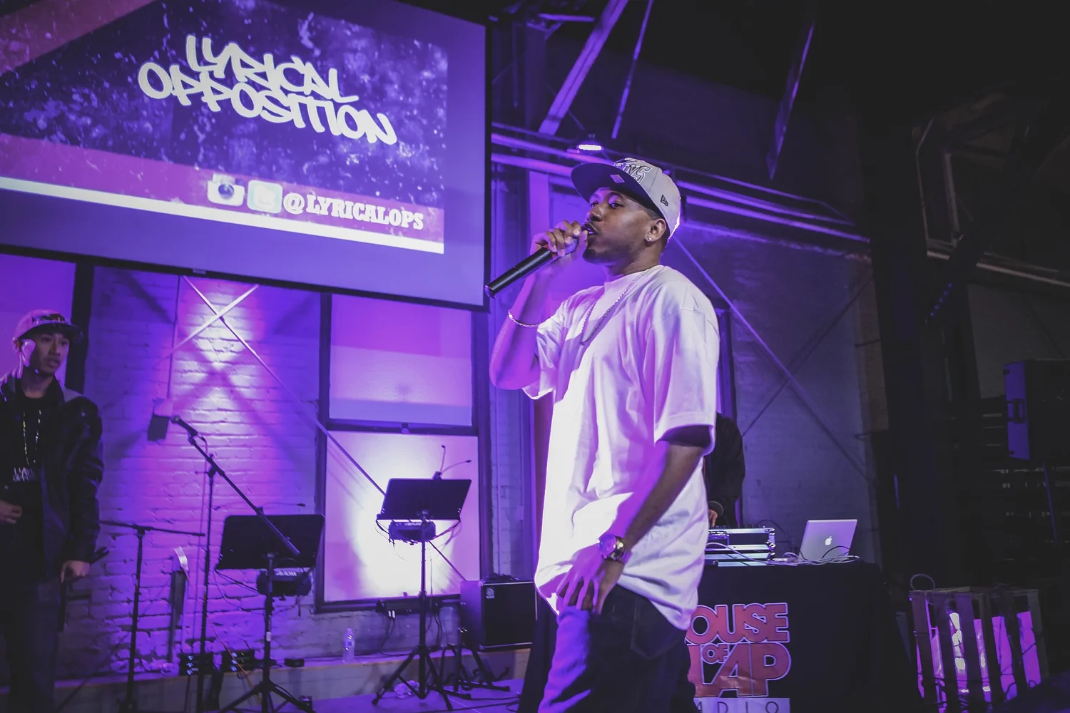 Vocalist performing beneath the Lyrical Opposition logo.