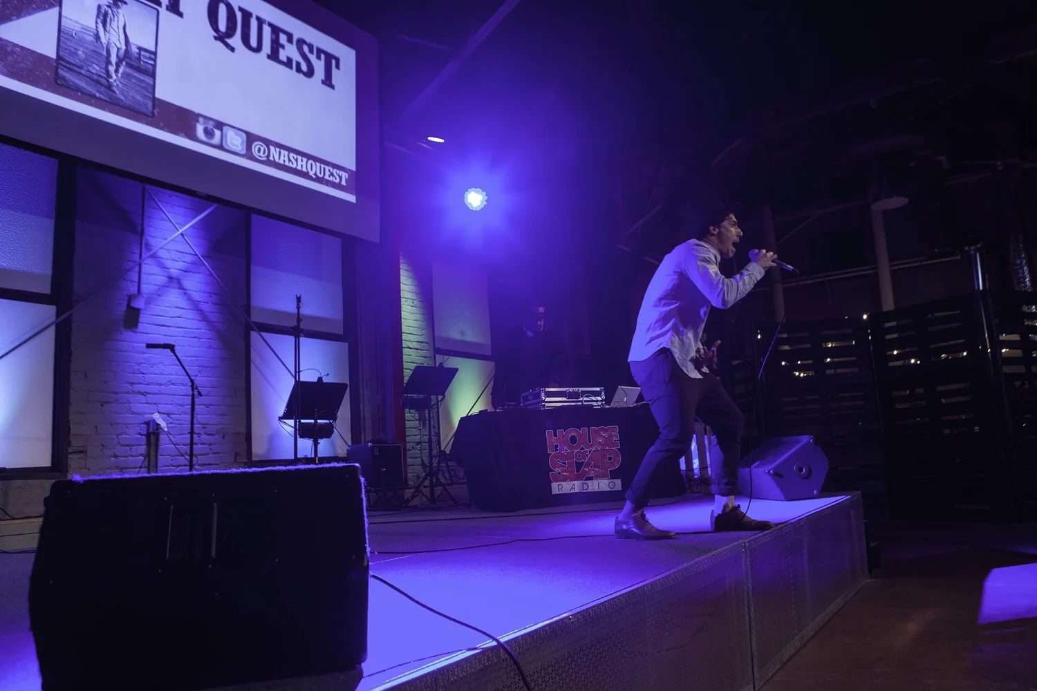 Low-angle view of a performer under purple lights.