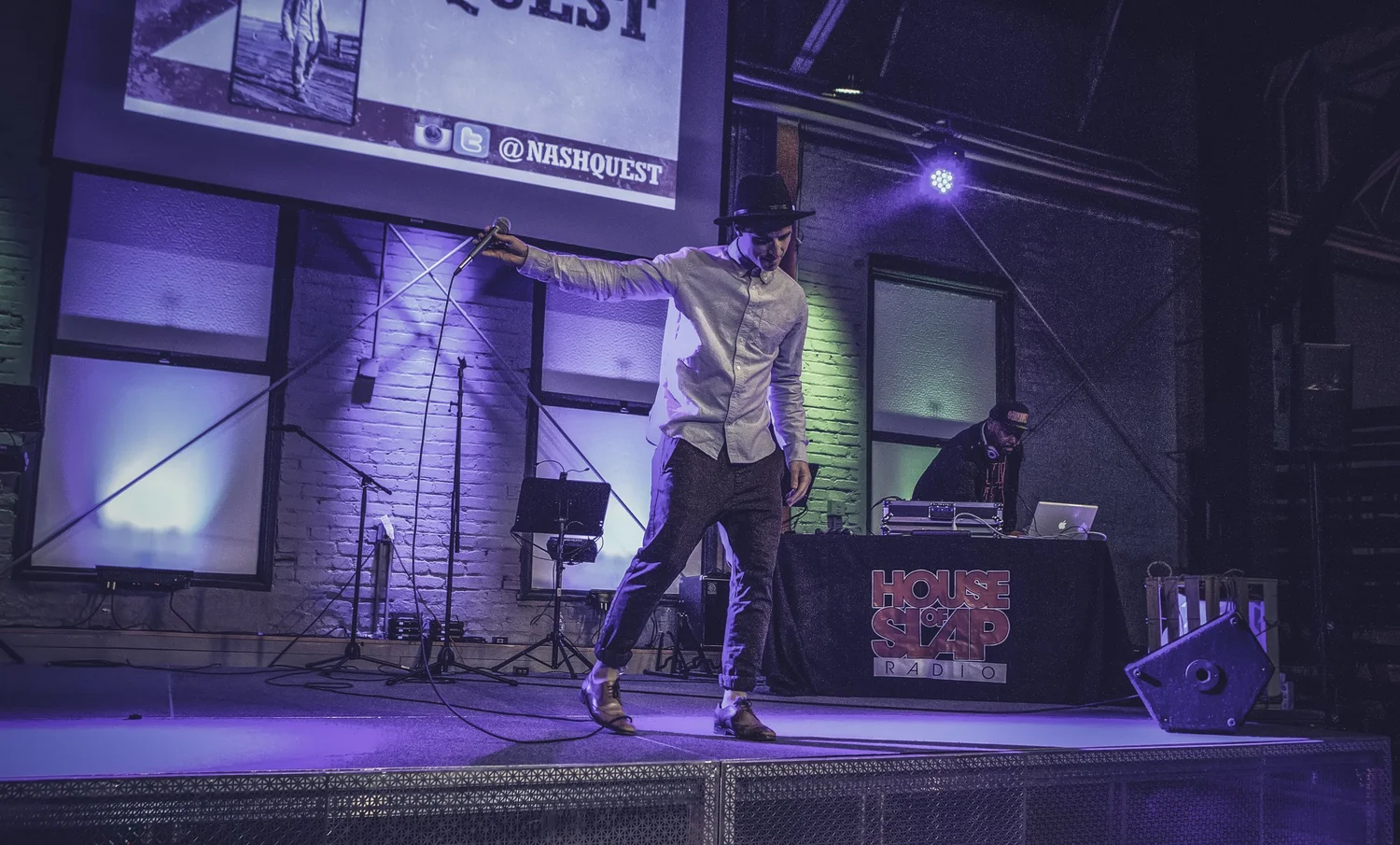 Performer extending an arm across the stage.