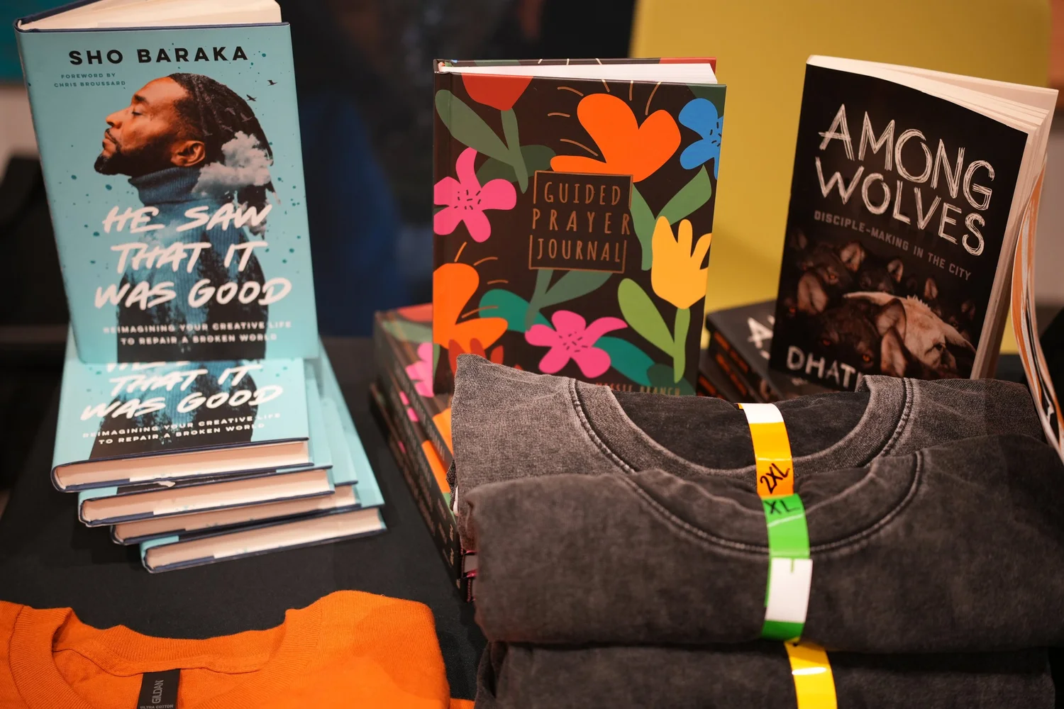 Books and clothing arranged on a display table.