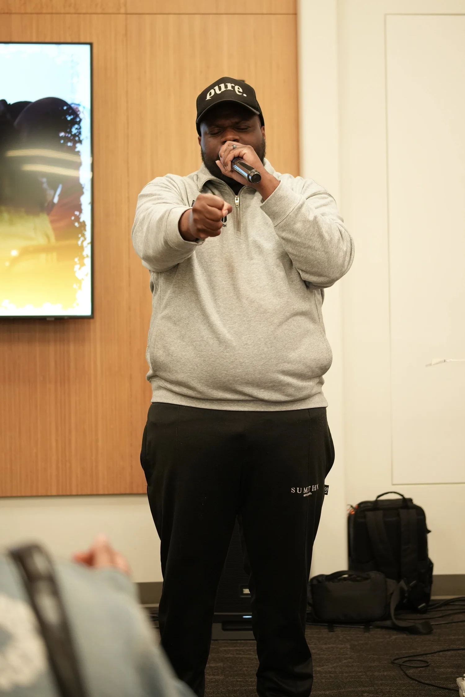 A performer speaks into a microphone during the community gathering.