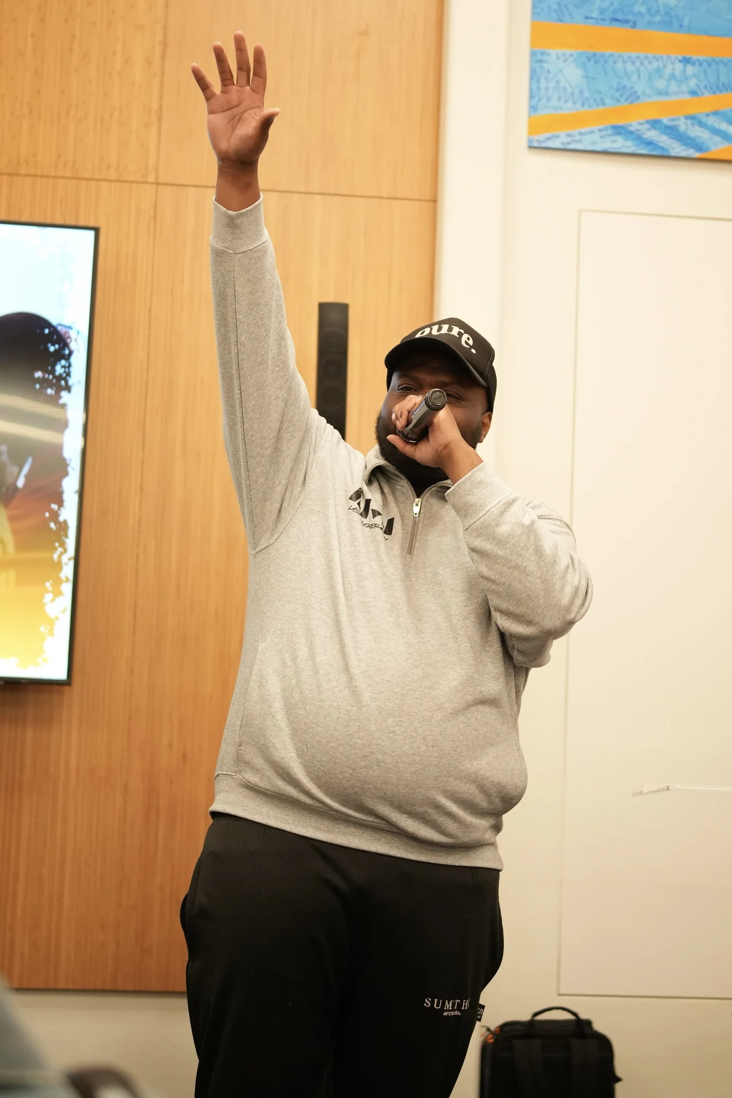 A performer speaks into a microphone during the community gathering.