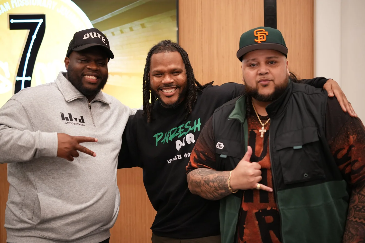 Artists smile together for a portrait at the Hub.