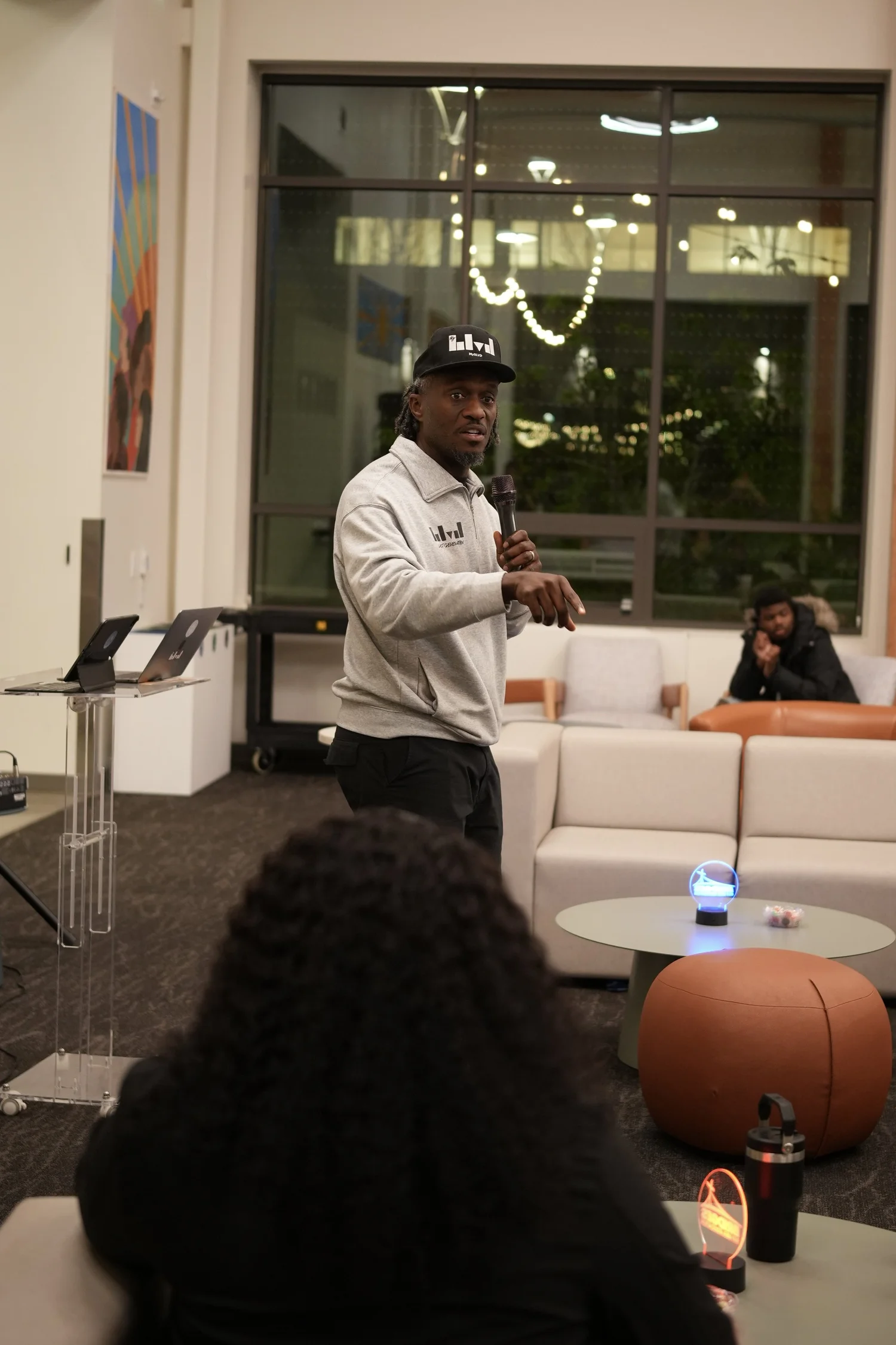 A performer speaks into a microphone during the community gathering.