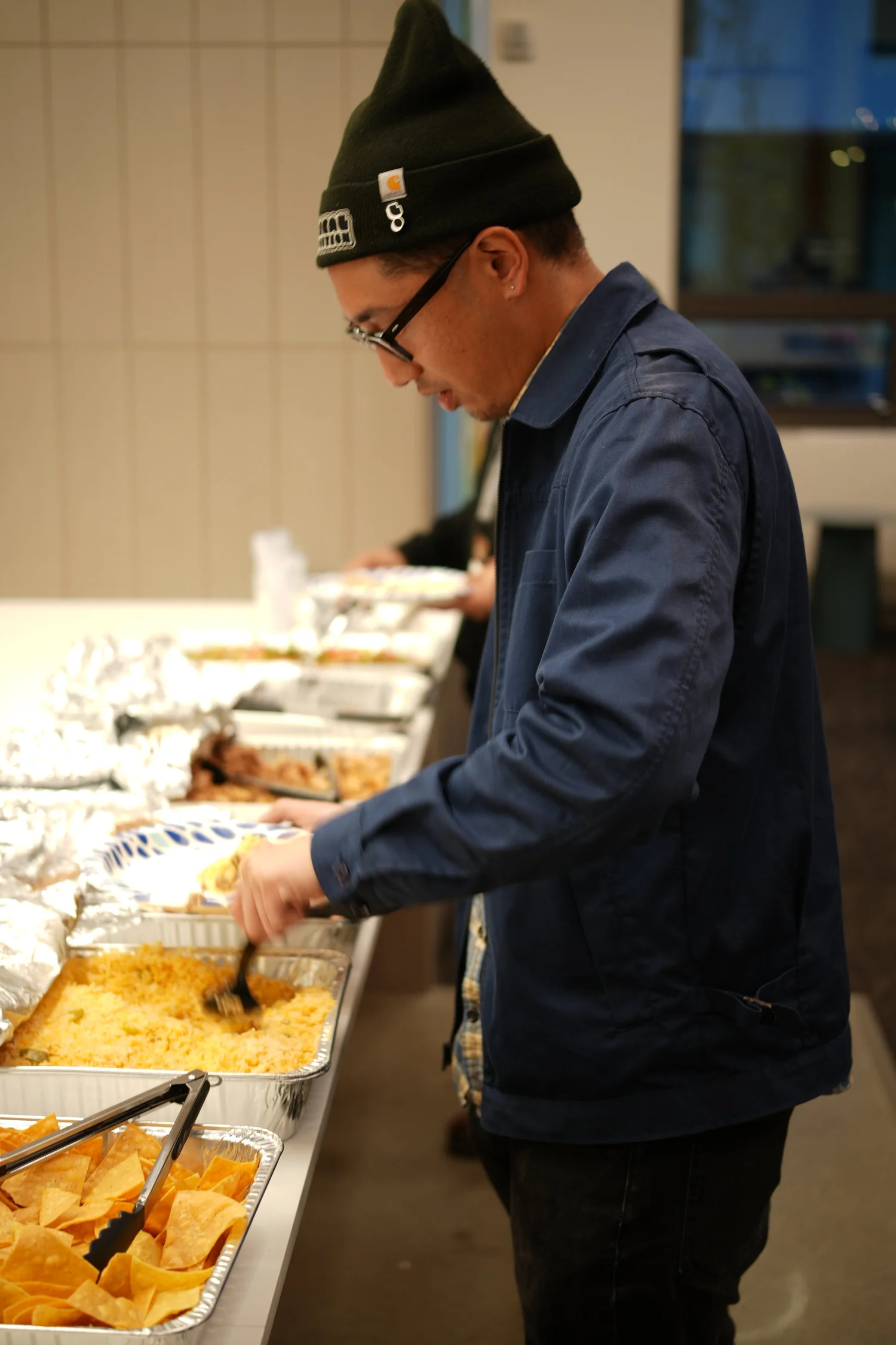 A guest serves food from the buffet.
