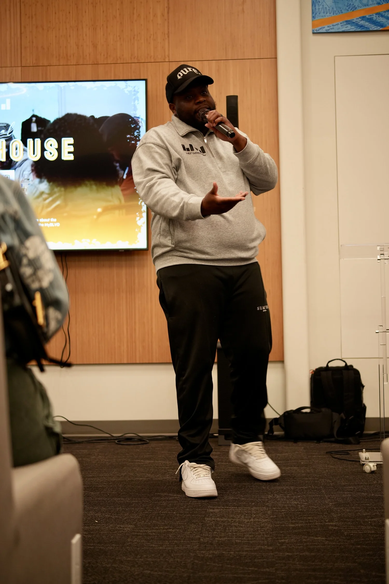 A performer speaks into a microphone during the community gathering.