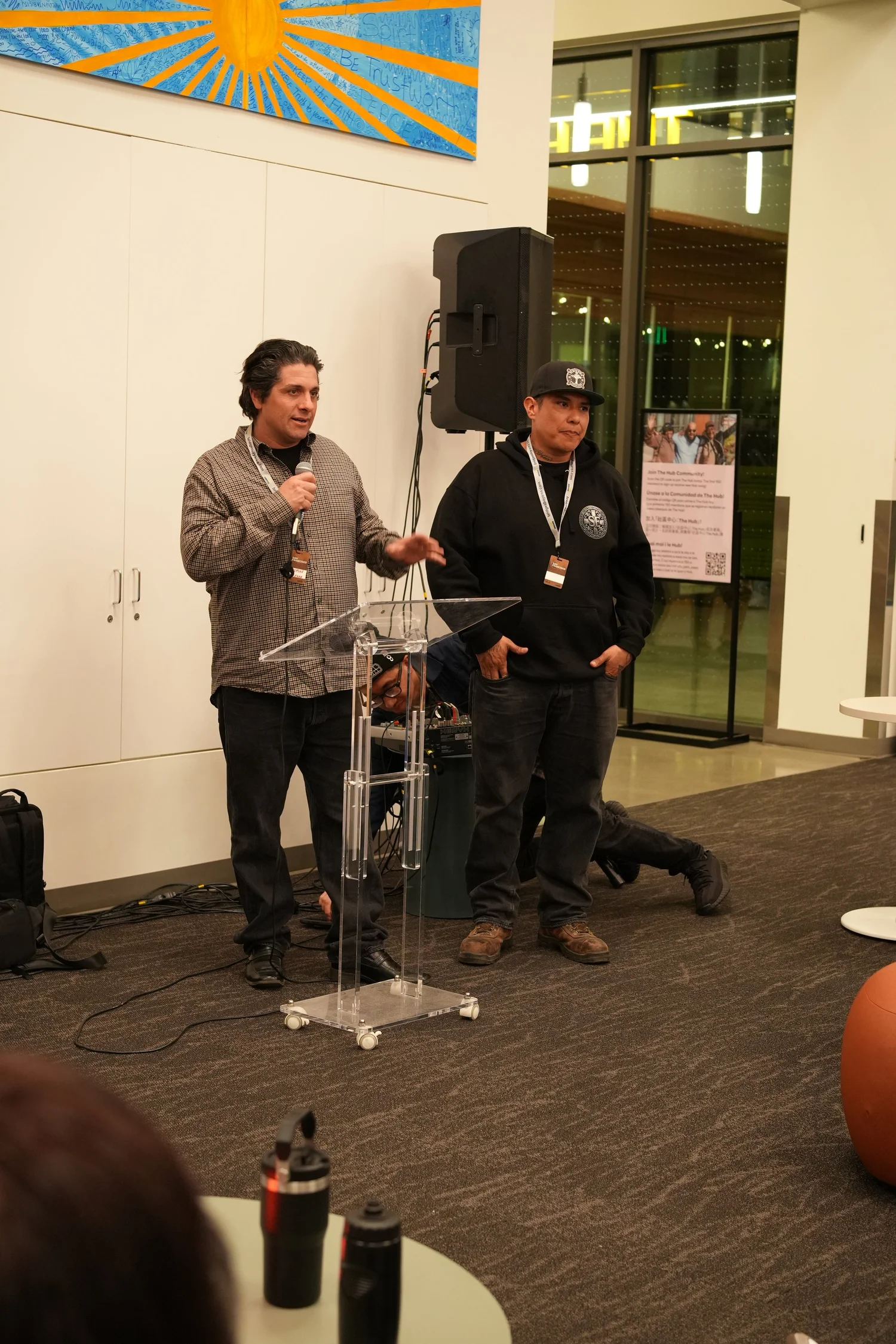 A performer speaks into a microphone during the community gathering.