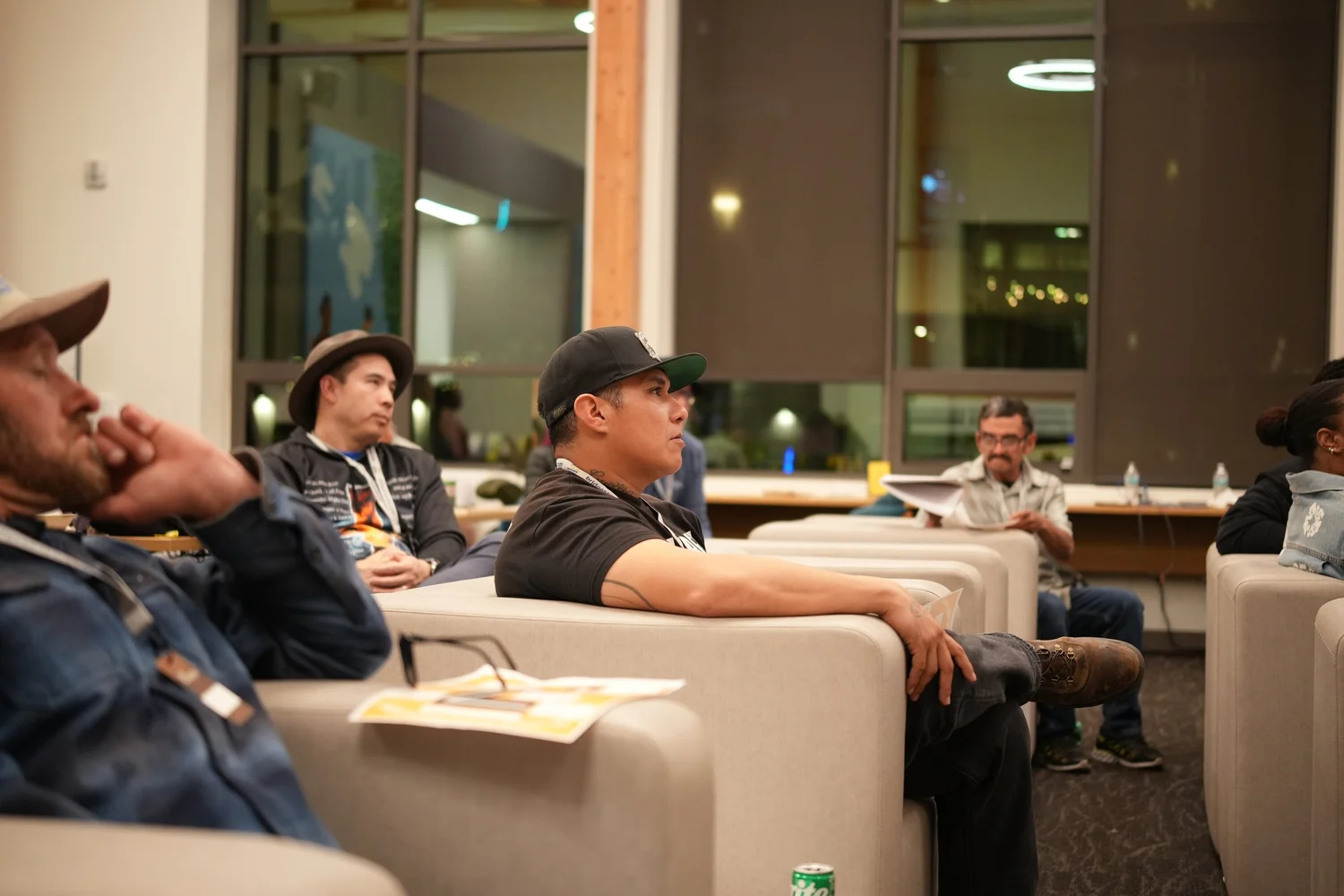 Audience members seated on sofas during the gathering.