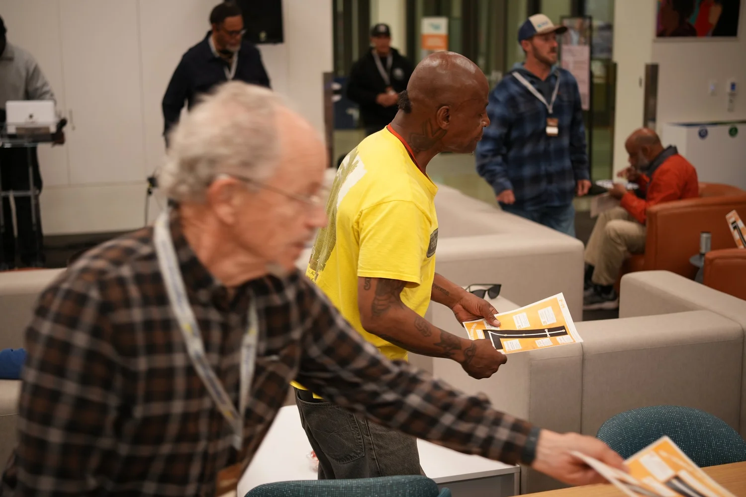 Attendees moving between tables and sofas.