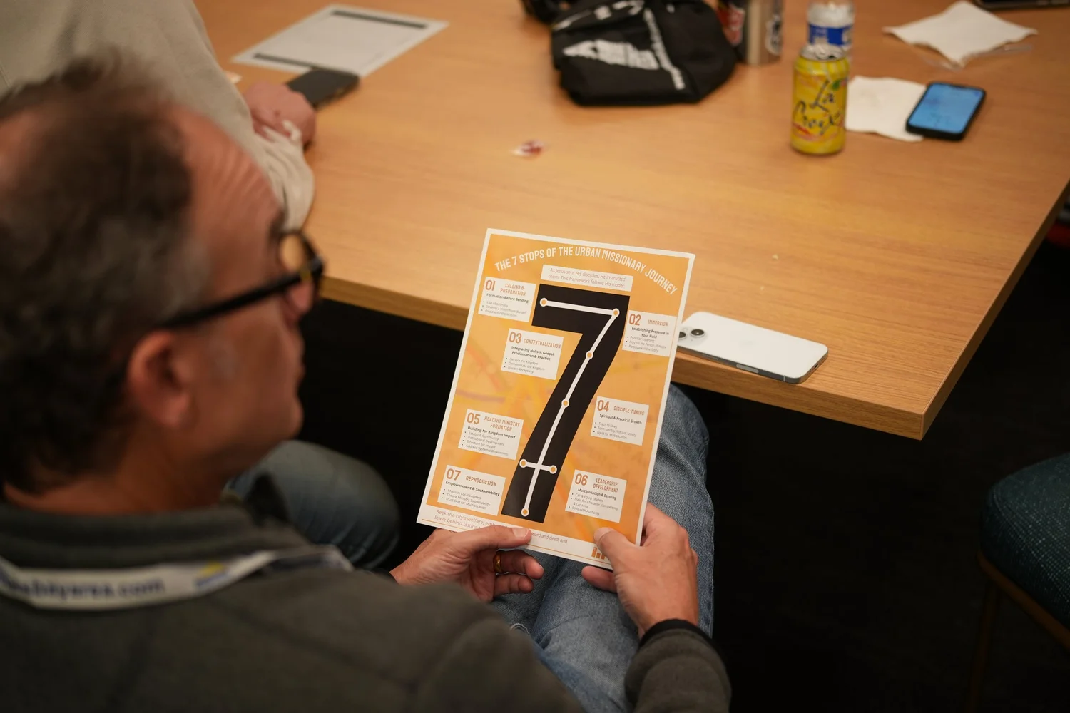 Attendee reading a Seven Stops handout.