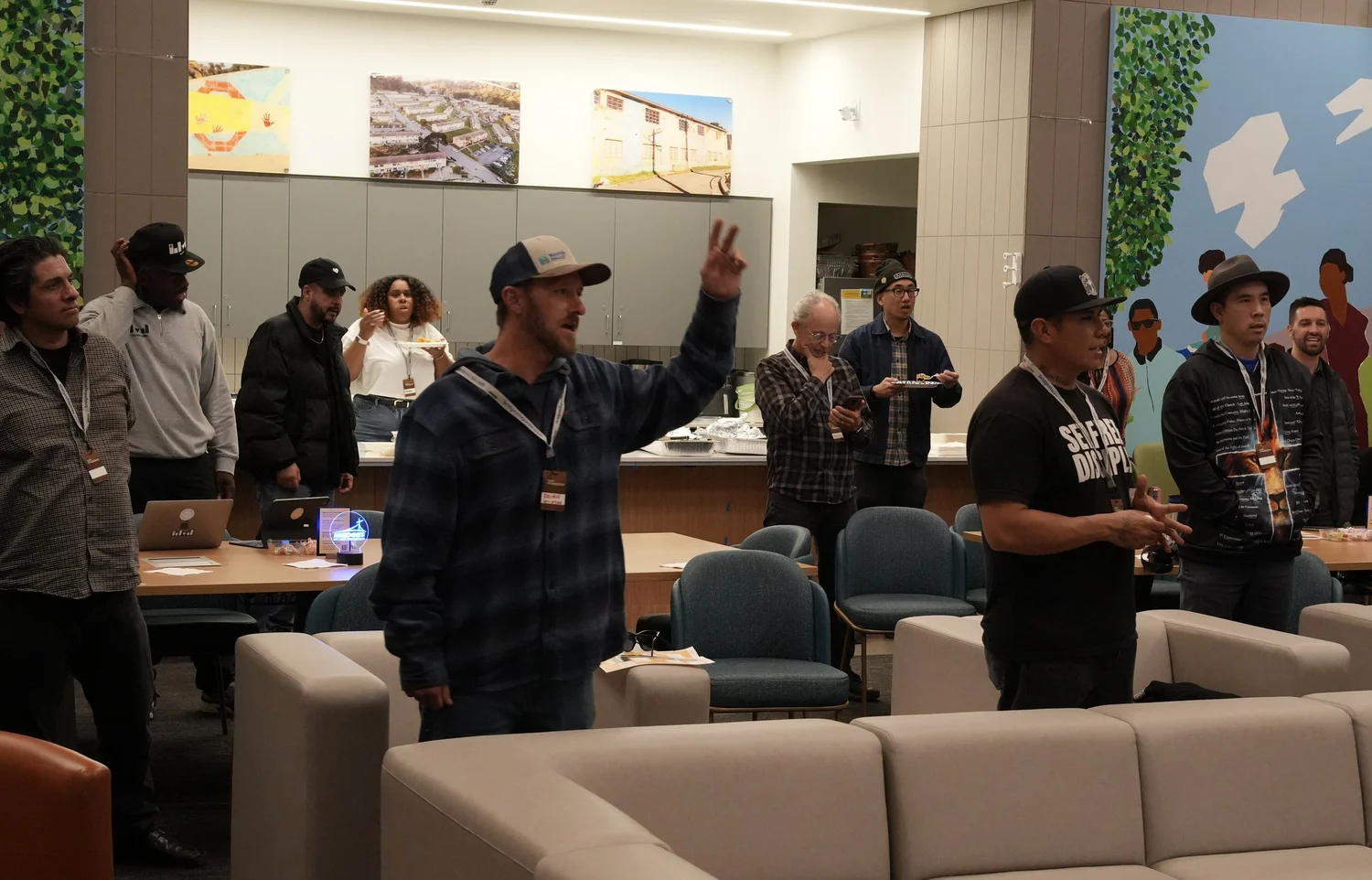 Attendees standing together with raised hands.