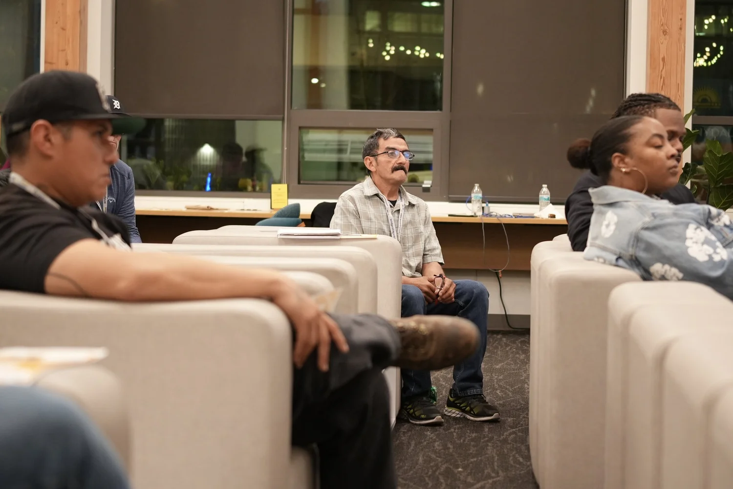 Audience members smiling from lounge seating.