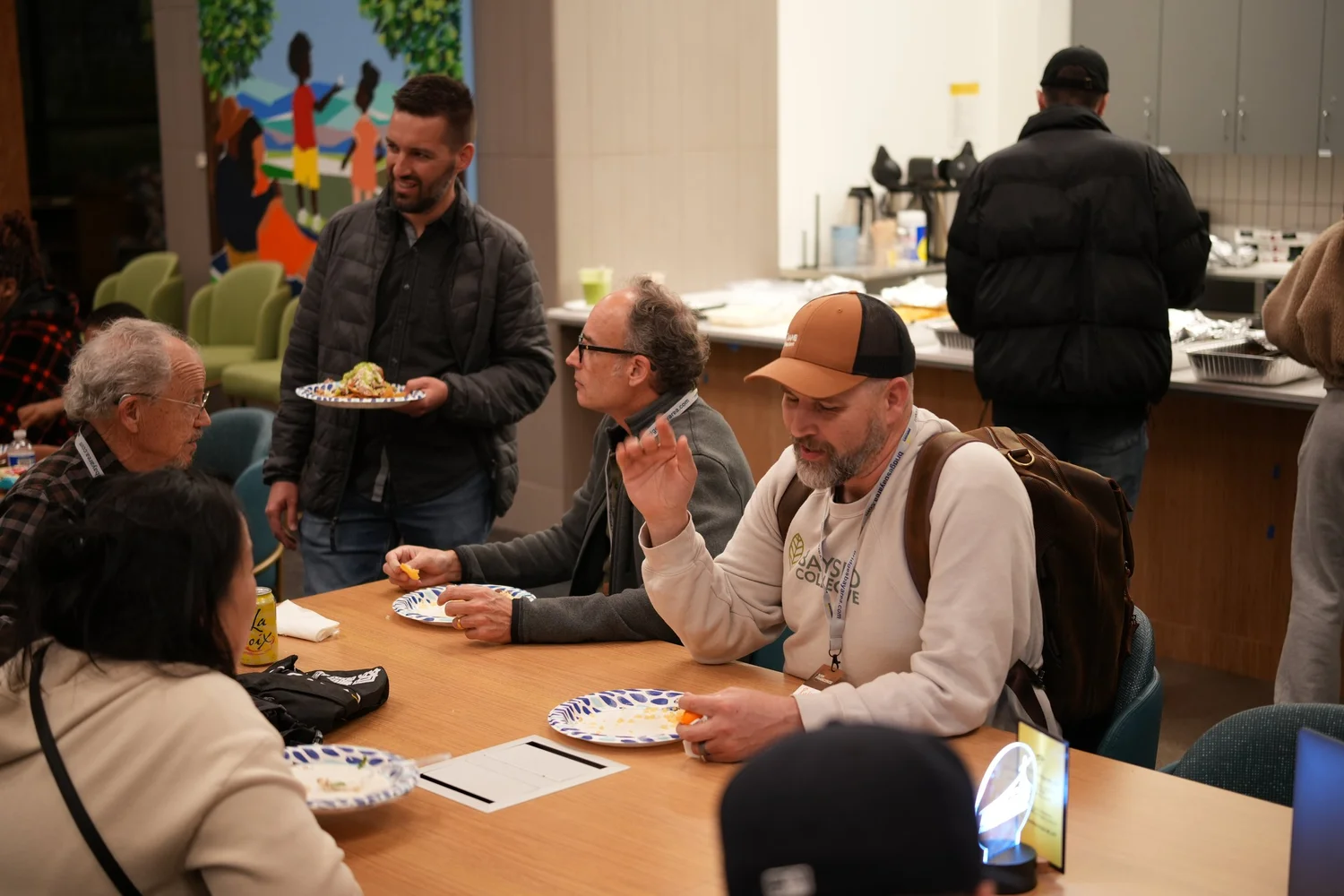 Guests eating and talking around a table.