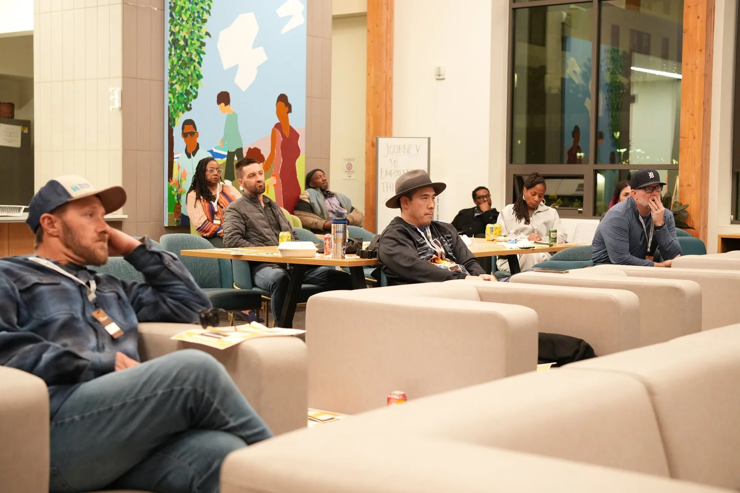 Audience seated across the community lounge.