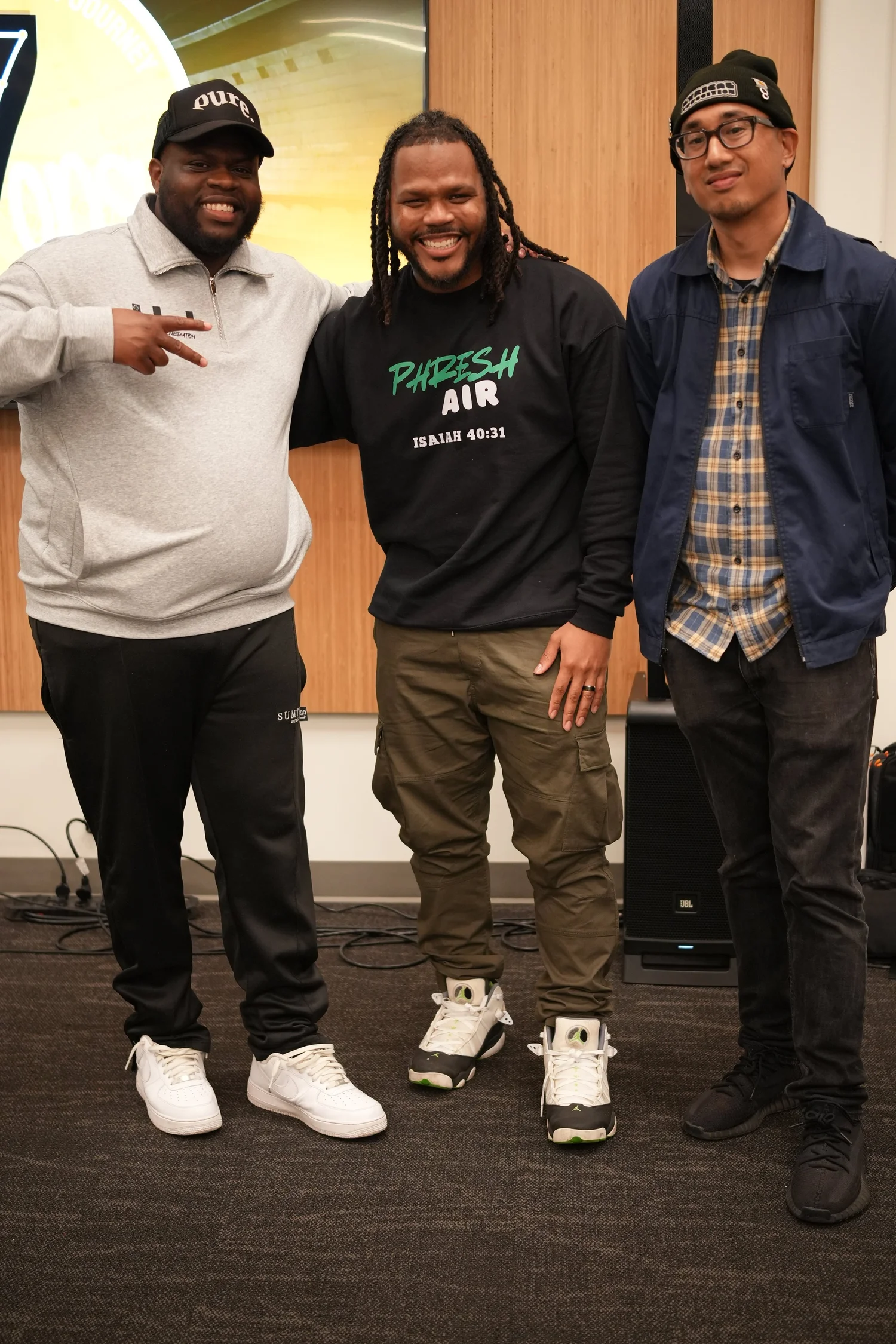 Three smiling participants posing together.